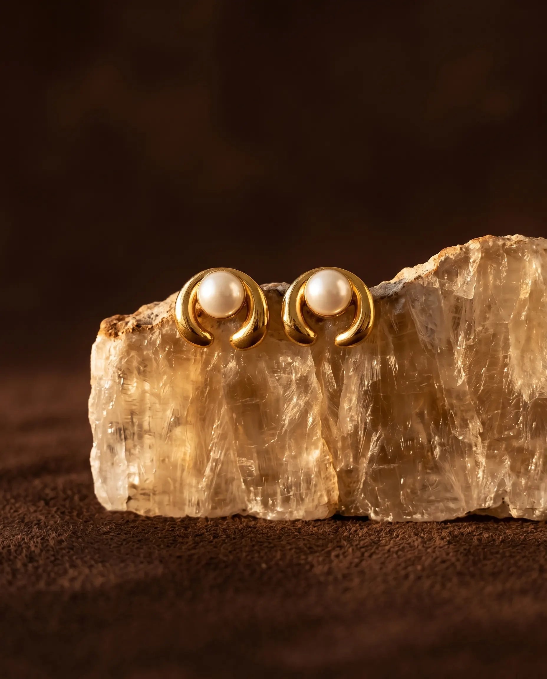 architectural-celine-pearl-earrings-artfully-displayed-on-natural-stone-minimalist-jewelry-photography-for-senya