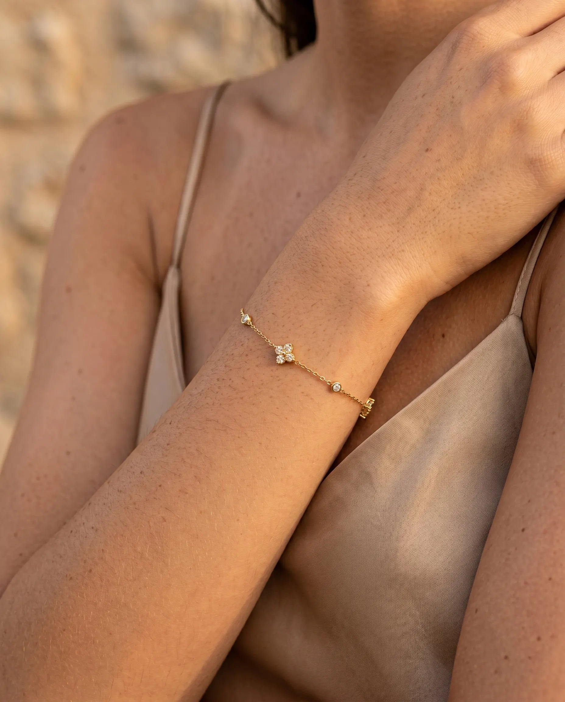 close-up-of-chloe-flower-bracelet-worn-by-model-to-emphasize-delicate-chain-and-stationed-charms