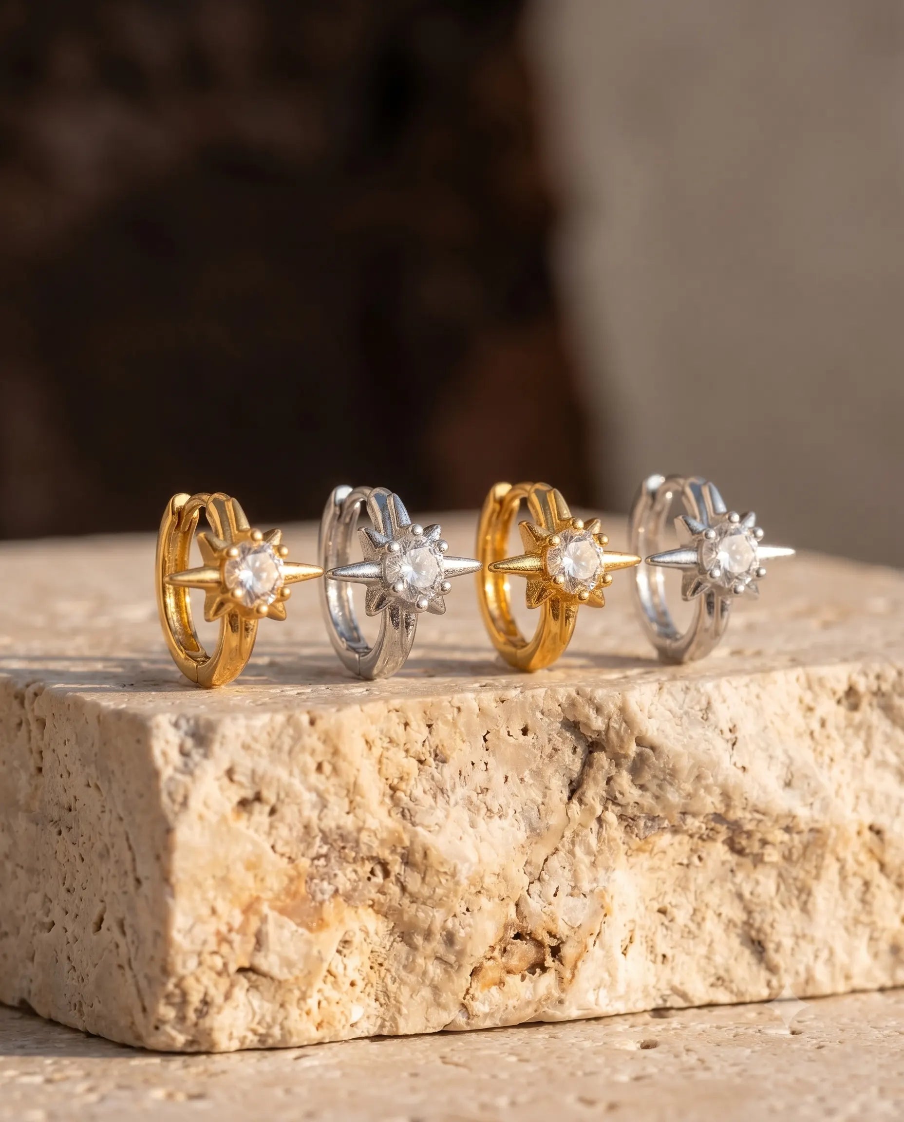 close-up-of-elanor-star-hoops-on-textured-stone-highlighting-zirconia-shimmer-and-sterling-silver-quality