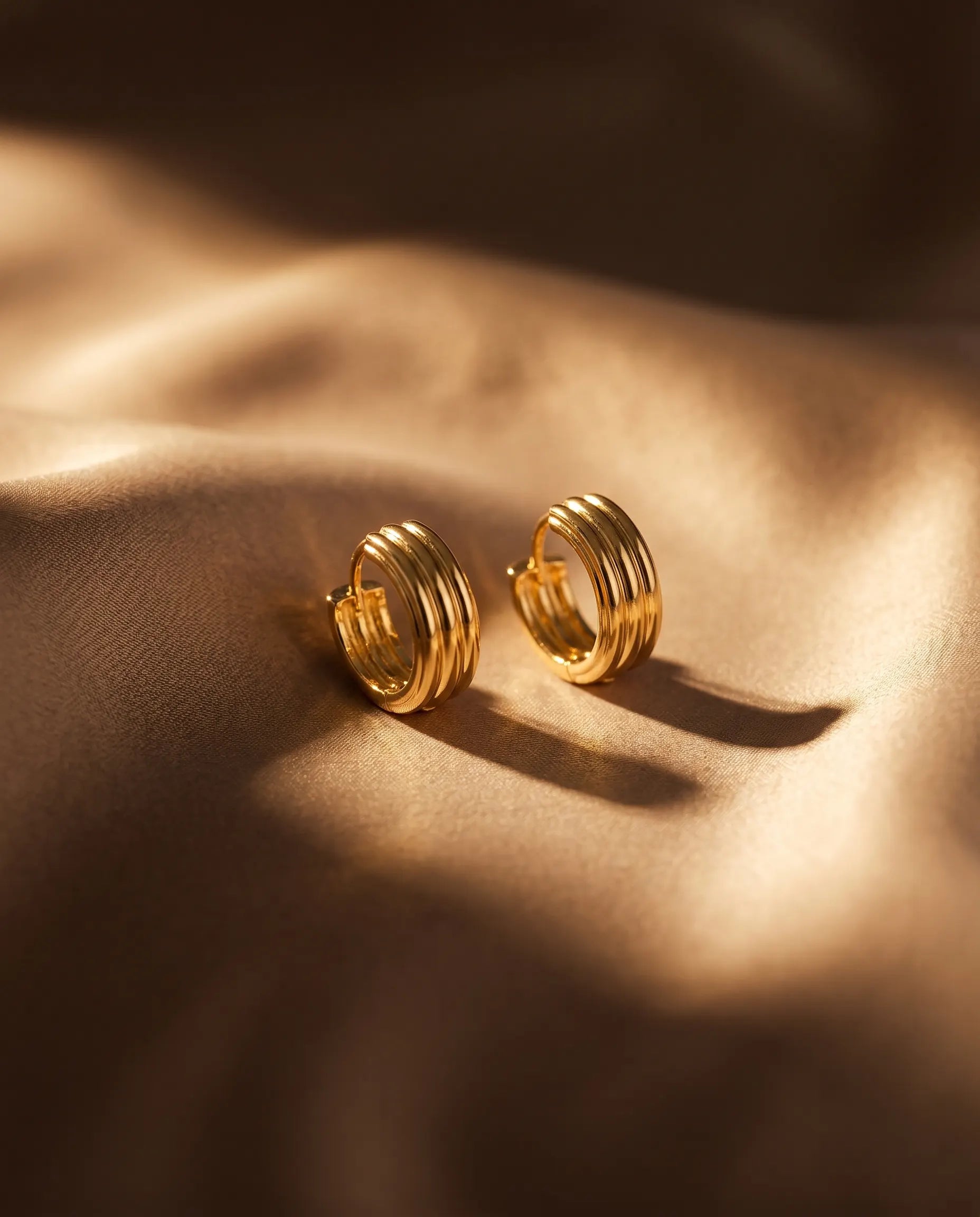 close-up-of-olive-textured-earrings-on-minimalist-display-showcasing-the-1.4cm-profile-and-high-polish-finish