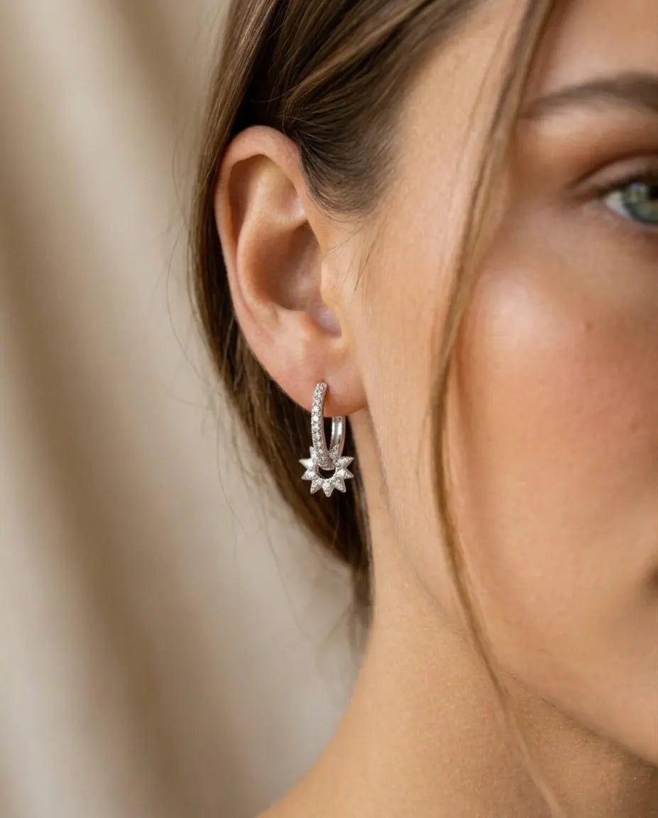 closeup-side-view-model-wearing-silver-sunlight-huggie-earrings, glowing-elegant-daily-wear-silver-jewelry-europe, luxury-women-professional-jewelry, feminine-architectural-celestial-hoops