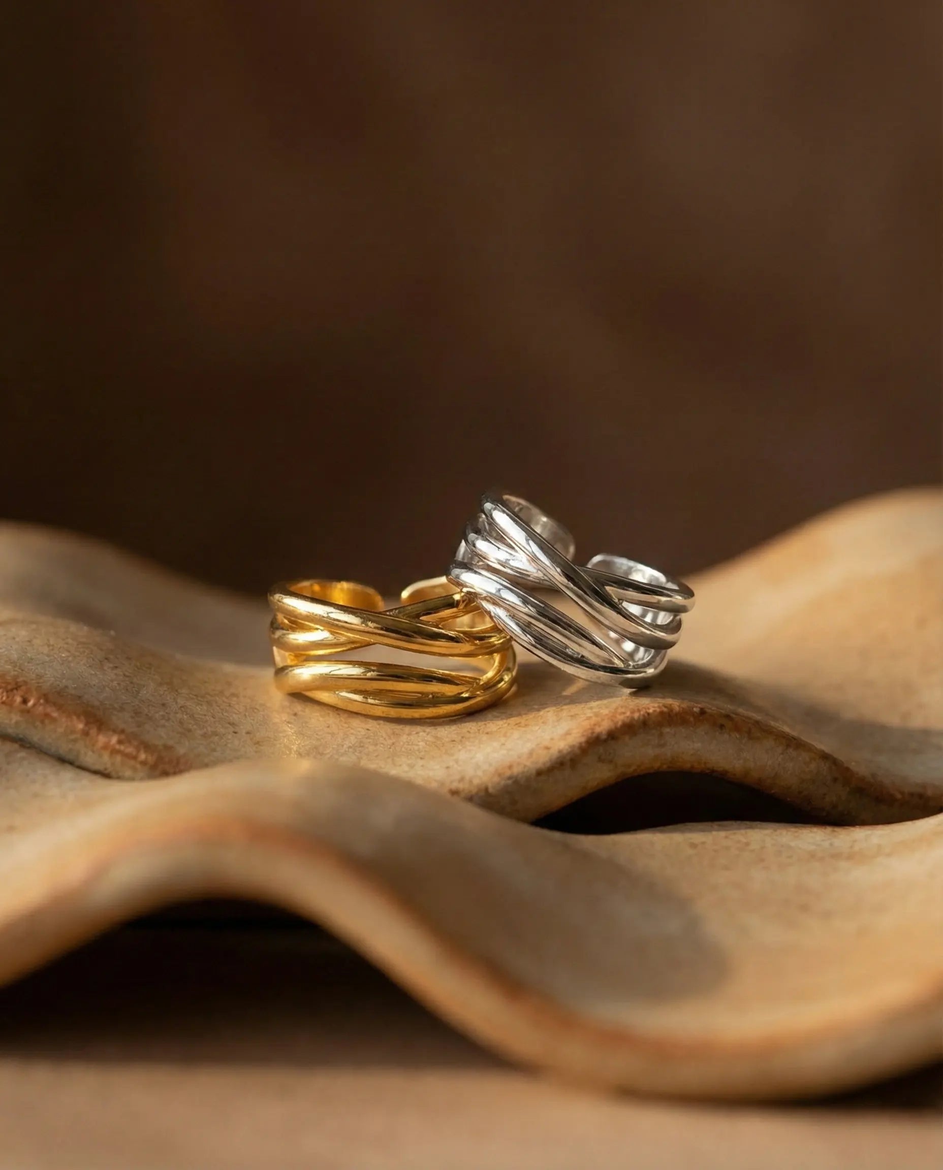 fluid-lines-crossover-ring-silver-gold, stacking-ring-ideas-minimalist, high-shine-925-silver-ring, anti-tarnish-gold-jewelry-testing, best-adjustable-ring-gift, refined-jewelry-flatlay-aesthetic