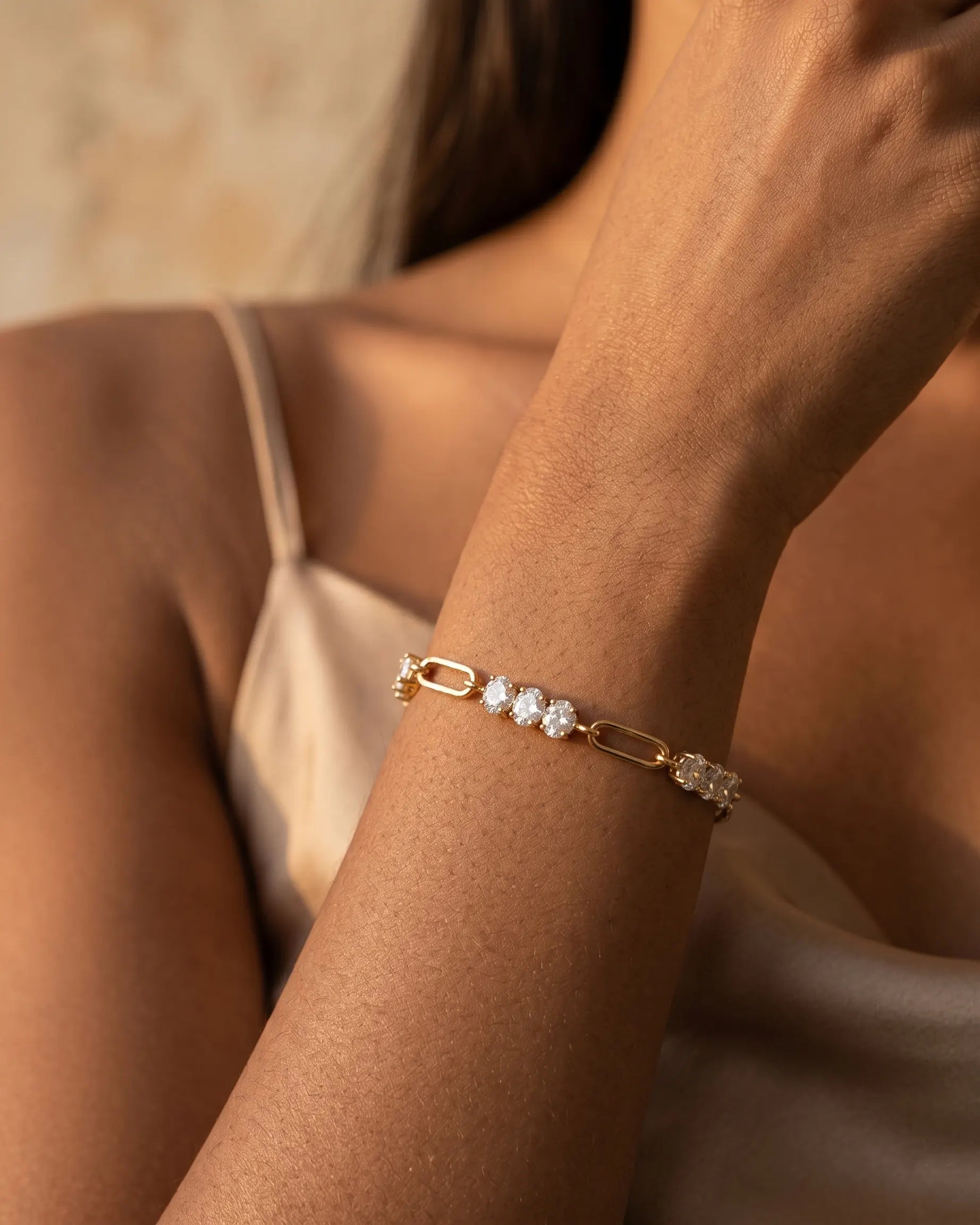 model-wearing-gold-aroma-crystal-bracelet-lifestyle, elegant-modern-feminine-jewelry-on-wrist, professional-women-luxury-accessories, chic-gold-paperclip-bracelet-styling, luxury-lifestyle-brand-model