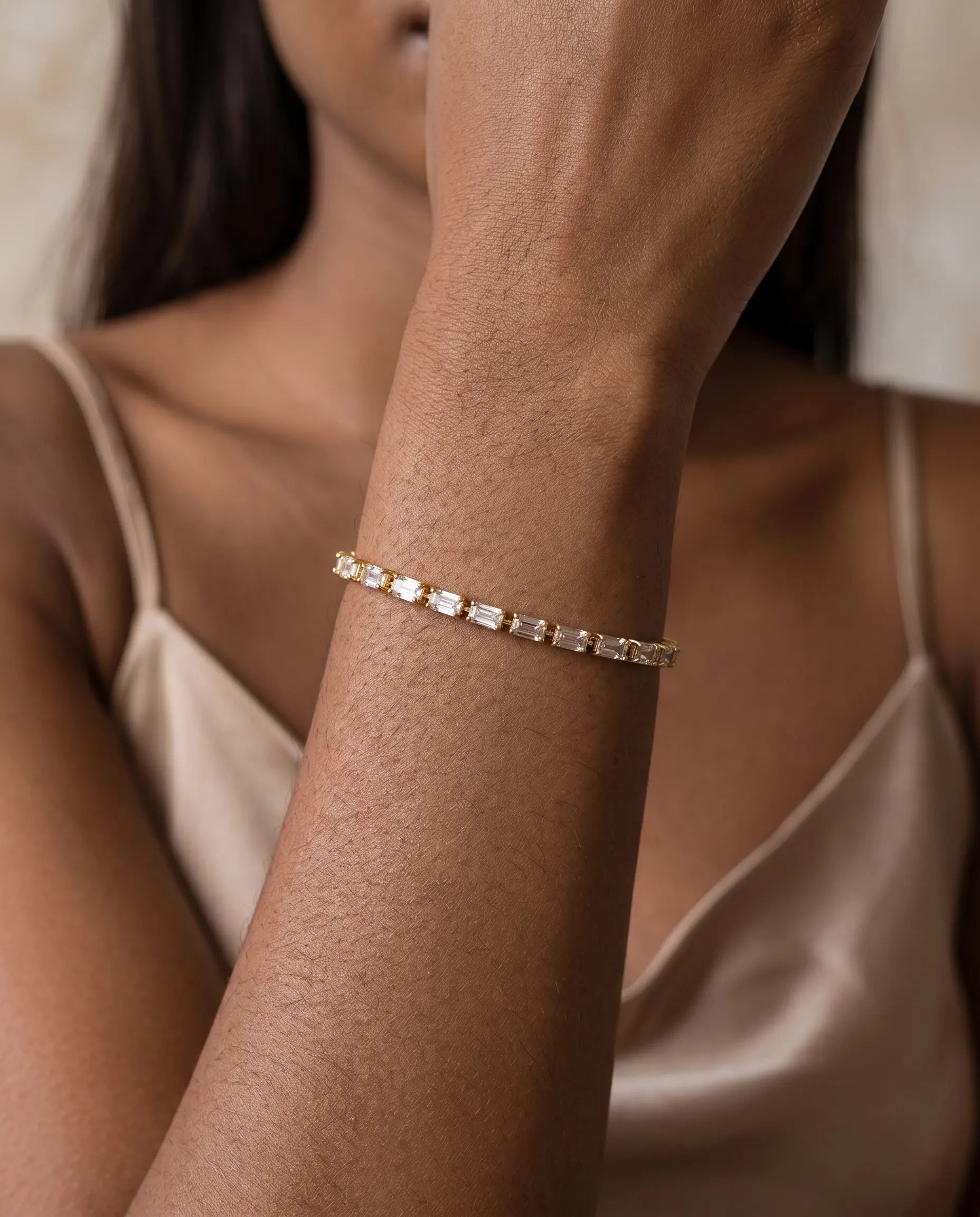 model-wearing-gold-bianca-zirconia-bracelet, elegant-sparkling-jewelry-lifestyle, professional-women-delicate-accessories, chic-minimalist-jewelry-photography, luxury-lifestyle-brand-model