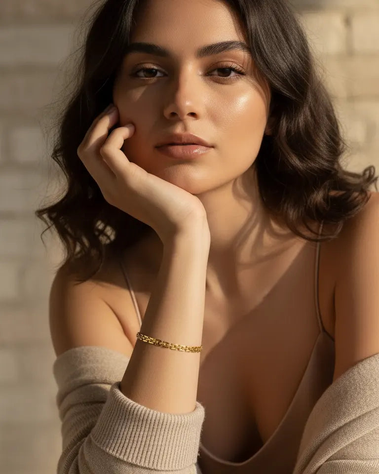 model-wearing-gold-caelina-curb-chain-bracelet, elegant-statement-jewelry-lifestyle, professional-women-jewelry-style, chic-minimalist-accessories-for-daily-wear, luxury-lifestyle-brand-photography, premium-jewelry-model-shot