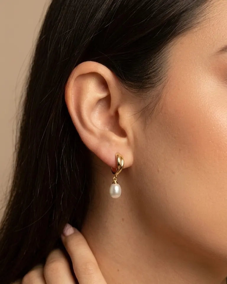 model-wearing-gold-capri-pearl-drop-earrings-lifestyle, elegant-modern-radiance-jewelry-on-ear, professional-women-luxury-accessories, chic-freshwater-pearl-earrings-photography, luxury-lifestyle-brand-model
