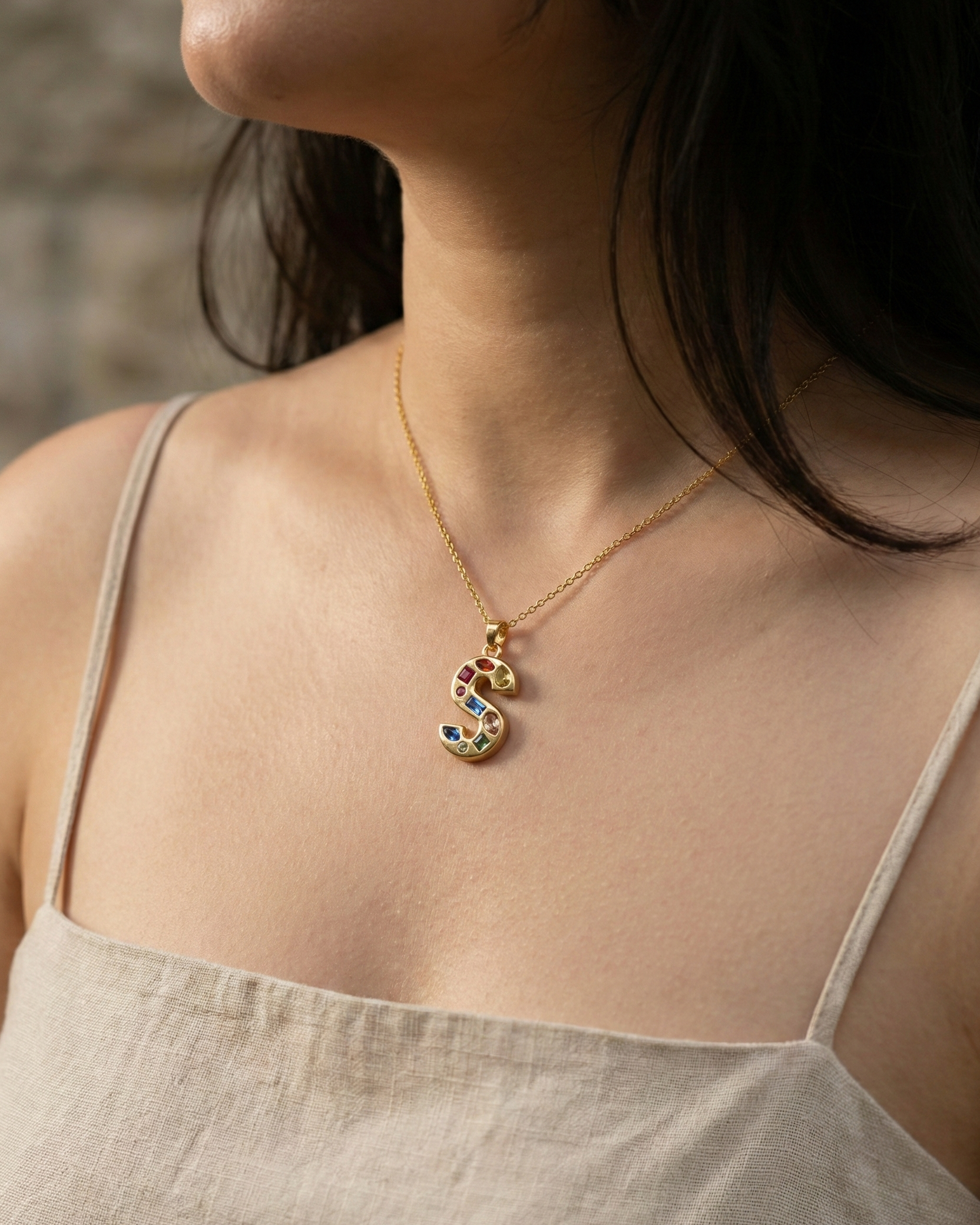 model-wearing-gold-crystal-initial-necklace, elegant-personalized-jewelry-lifestyle, professional-women-custom-necklace-style, chic-maximalist-accessories-photography, luxury-lifestyle-brand-model, premium-initial-pendant-on-neck