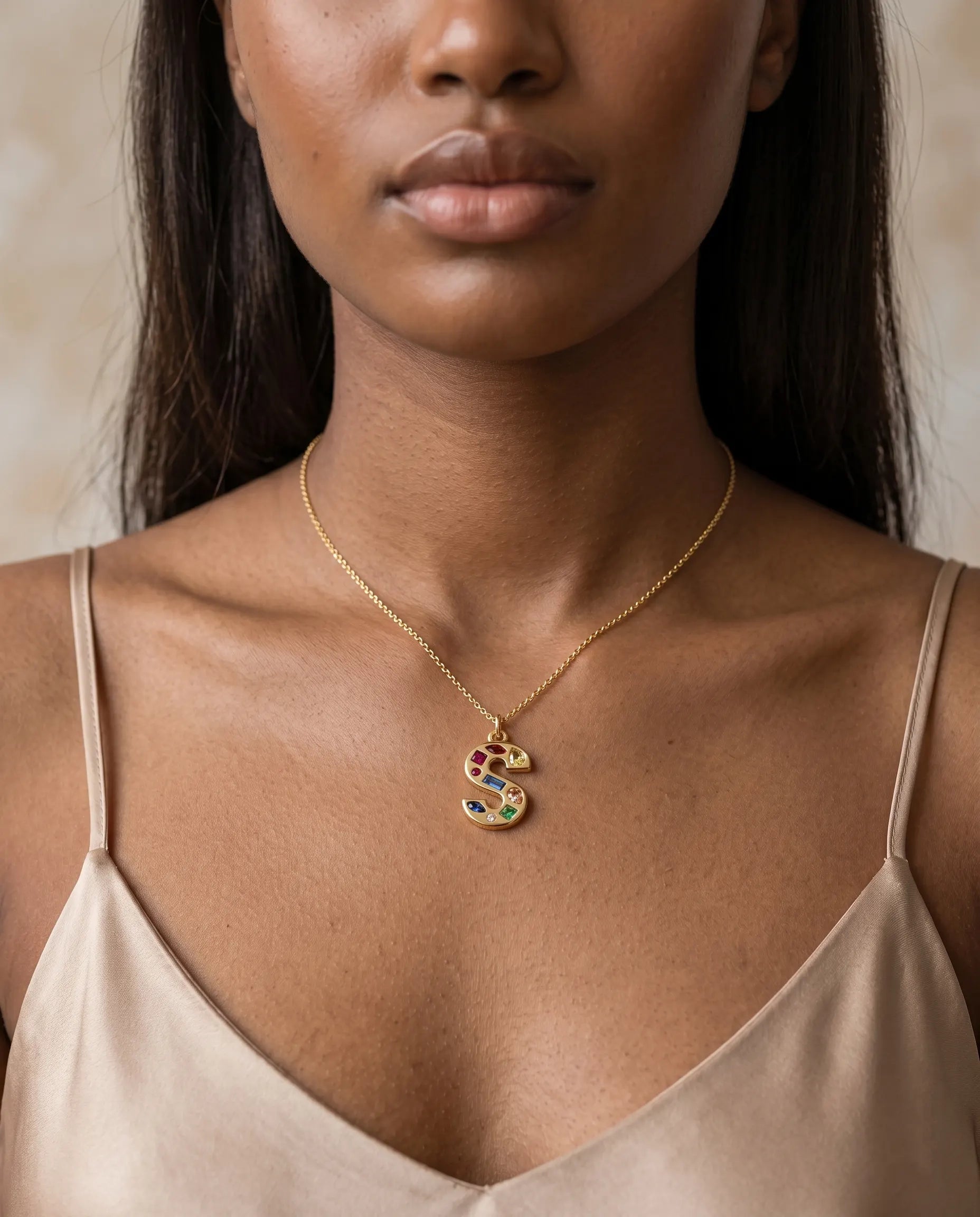 model-wearing-gold-crystal-initial-necklace, elegant-personalized-jewelry-lifestyle, professional-women-custom-necklace-style, chic-maximalist-accessories-photography, luxury-lifestyle-brand-model, premium-initial-pendant-on-neck