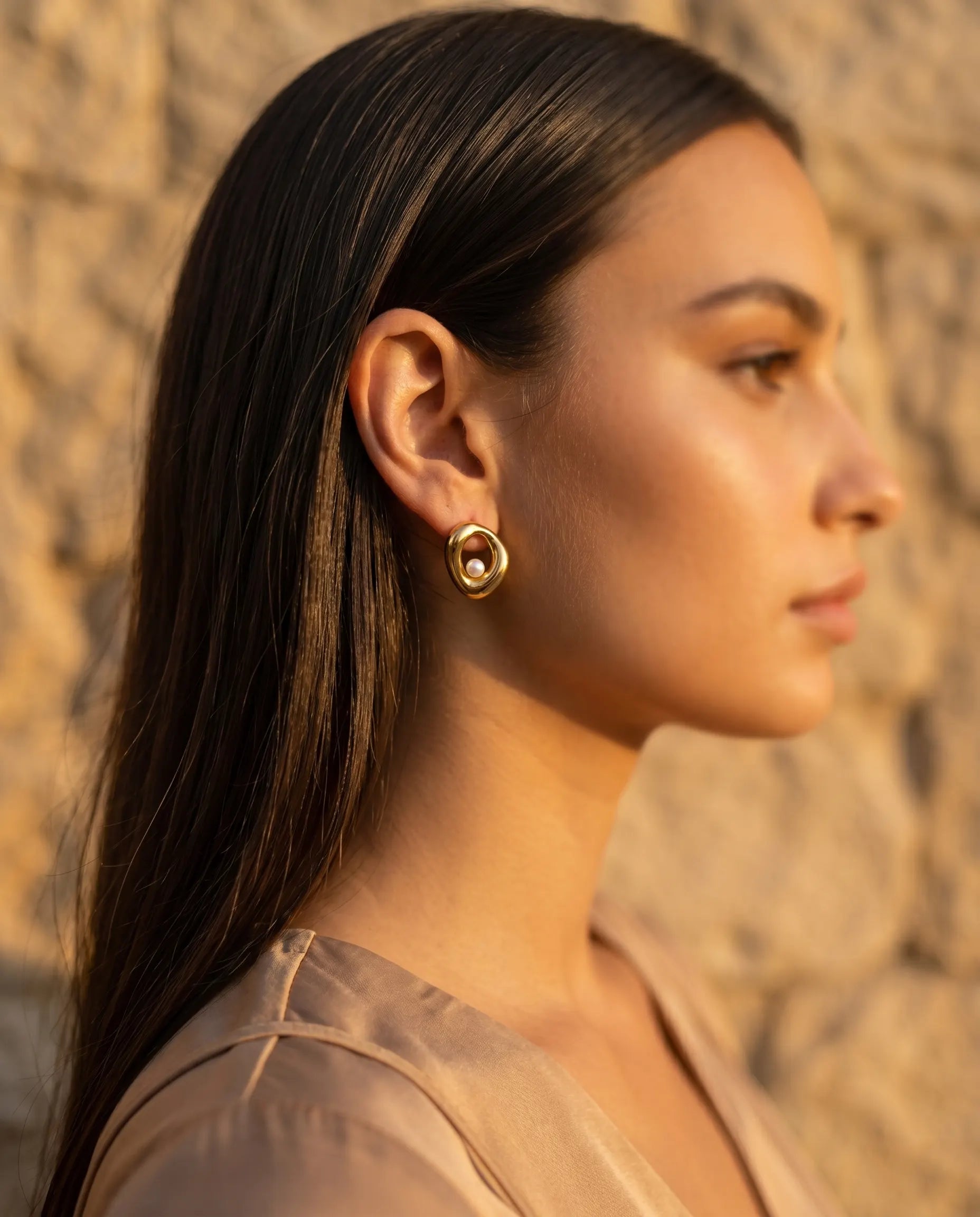 model-wearing-gold-cybelle-teardrop-earrings-lifestyle, elegant-modern-feminine-jewelry-on-ear, professional-women-luxury-accessories, chic-liquid-gold-styling, luxury-lifestyle-brand-model