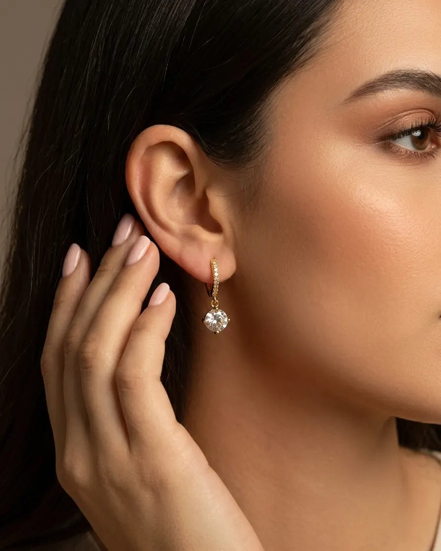 model-wearing-gold-dafne-drop-huggie-earrings-lifestyle, elegant-modern-feminine-jewelry-on-ear, professional-women-luxury-accessories, chic-solitaire-gold-styling, luxury-lifestyle-brand-model