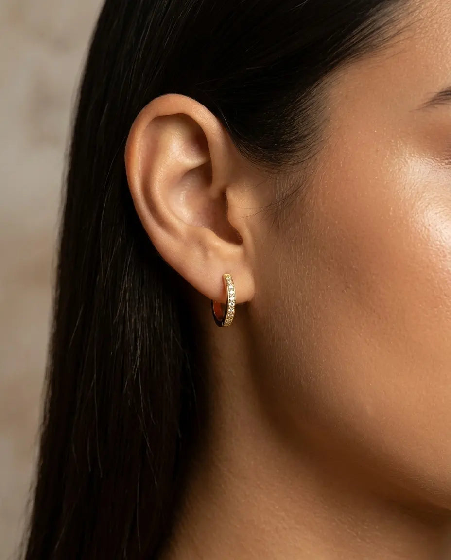 model-wearing-gold-emery-zirconia-hoops, elegant-timeless-jewelry-lifestyle, professional-women-jewelry-style, chic-minimalist-accessories-photography, luxury-lifestyle-brand-model