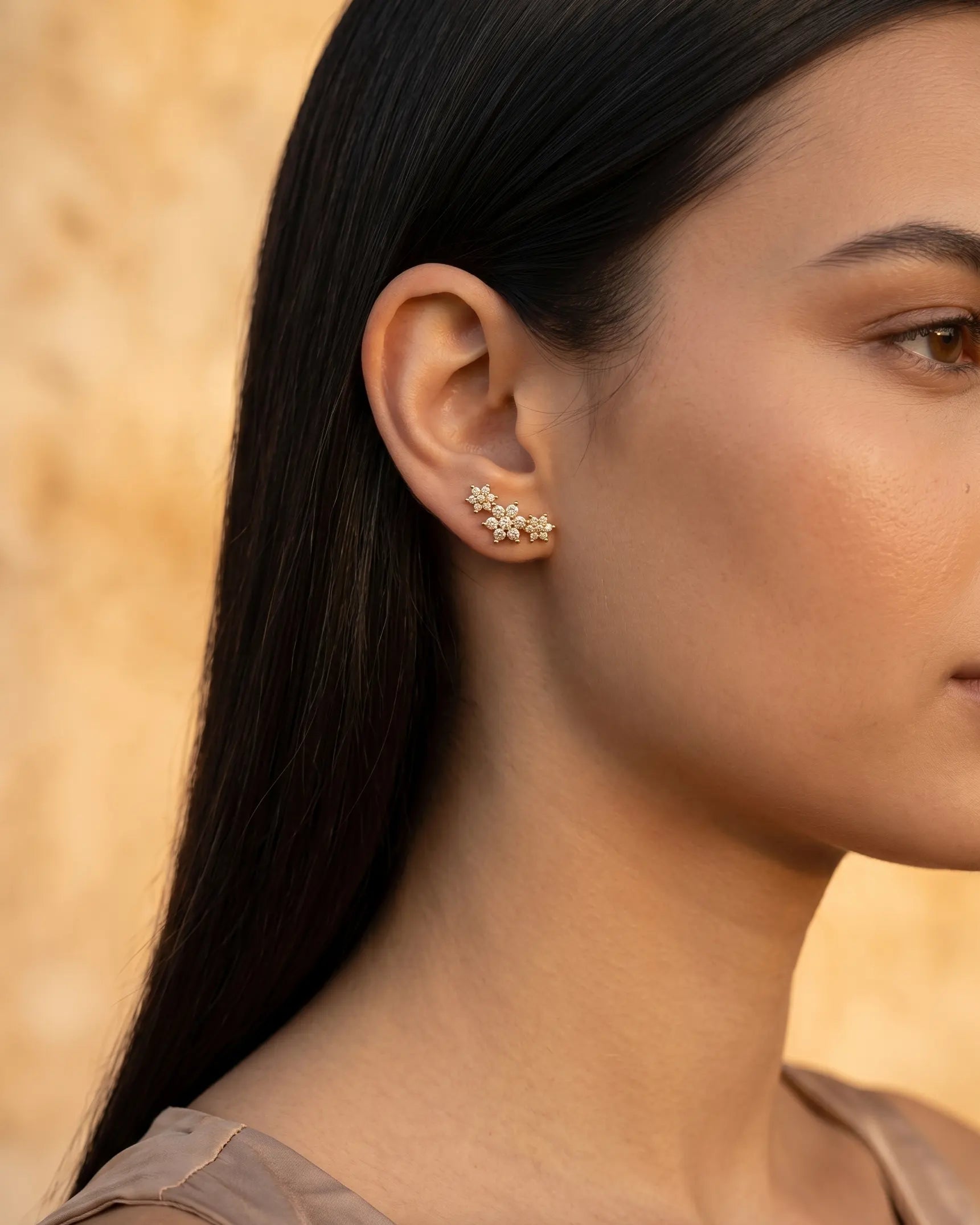 model-wearing-gold-flower-stud-earrings, elegant-feminine-jewelry-lifestyle, dainty-sparkle-earrings-on-ear, professional-women-floral-jewelry, luxury-lifestyle-brand-photography, chic-minimalist-accessories-model