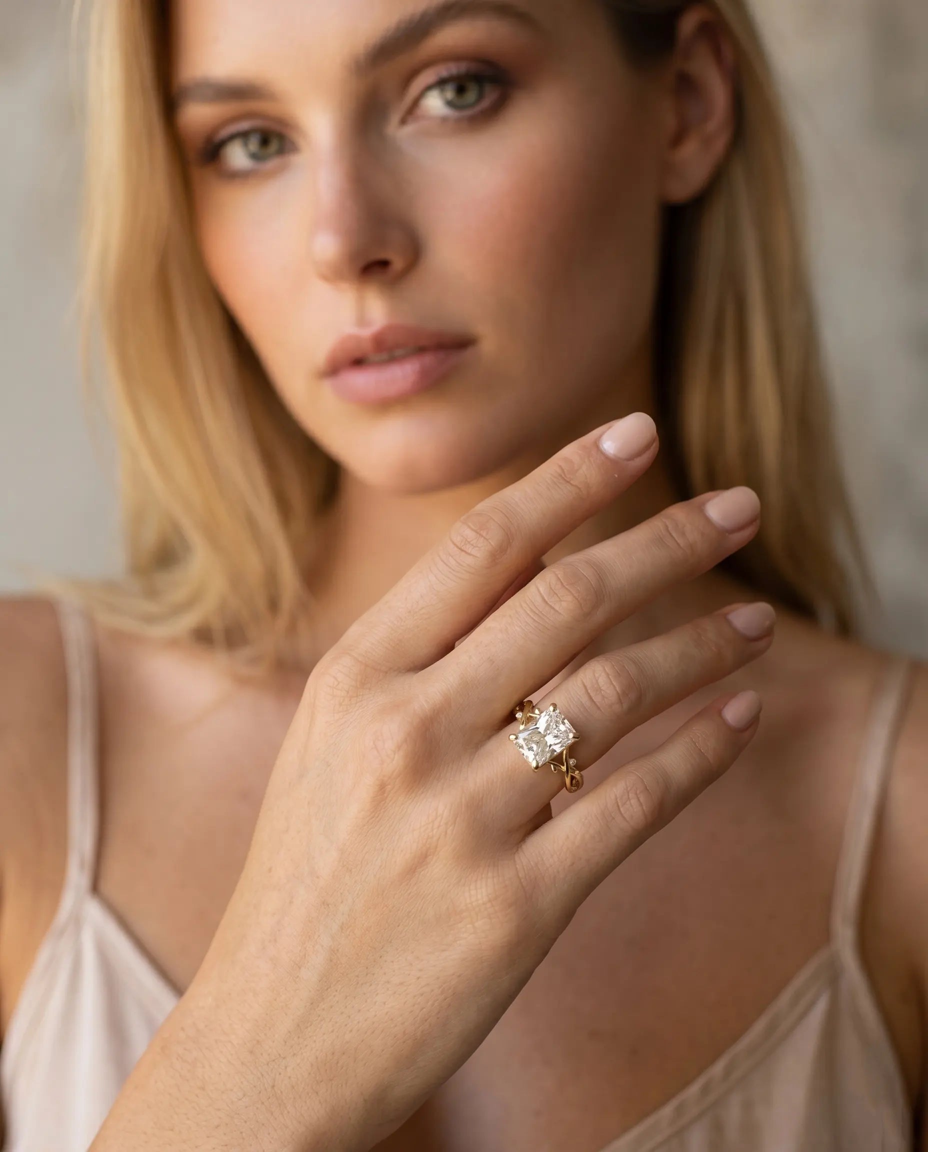model-wearing-gold-hera-emerald-cut-ring-lifestyle, elegant-modern-sovereign-jewelry-on-hand, professional-women-luxury-accessories, chic-zirconia-statement-ring-styling, luxury-lifestyle-brand-model