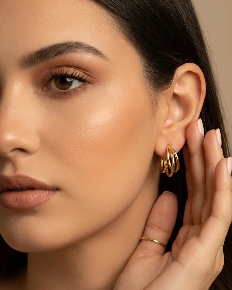 model-wearing-gold-lola-triple-layer-hoops-lifestyle, elegant-modern-feminine-jewelry-on-ear, professional-women-luxury-accessories, chic-multi-layered-gold-styling, luxury-lifestyle-brand-model