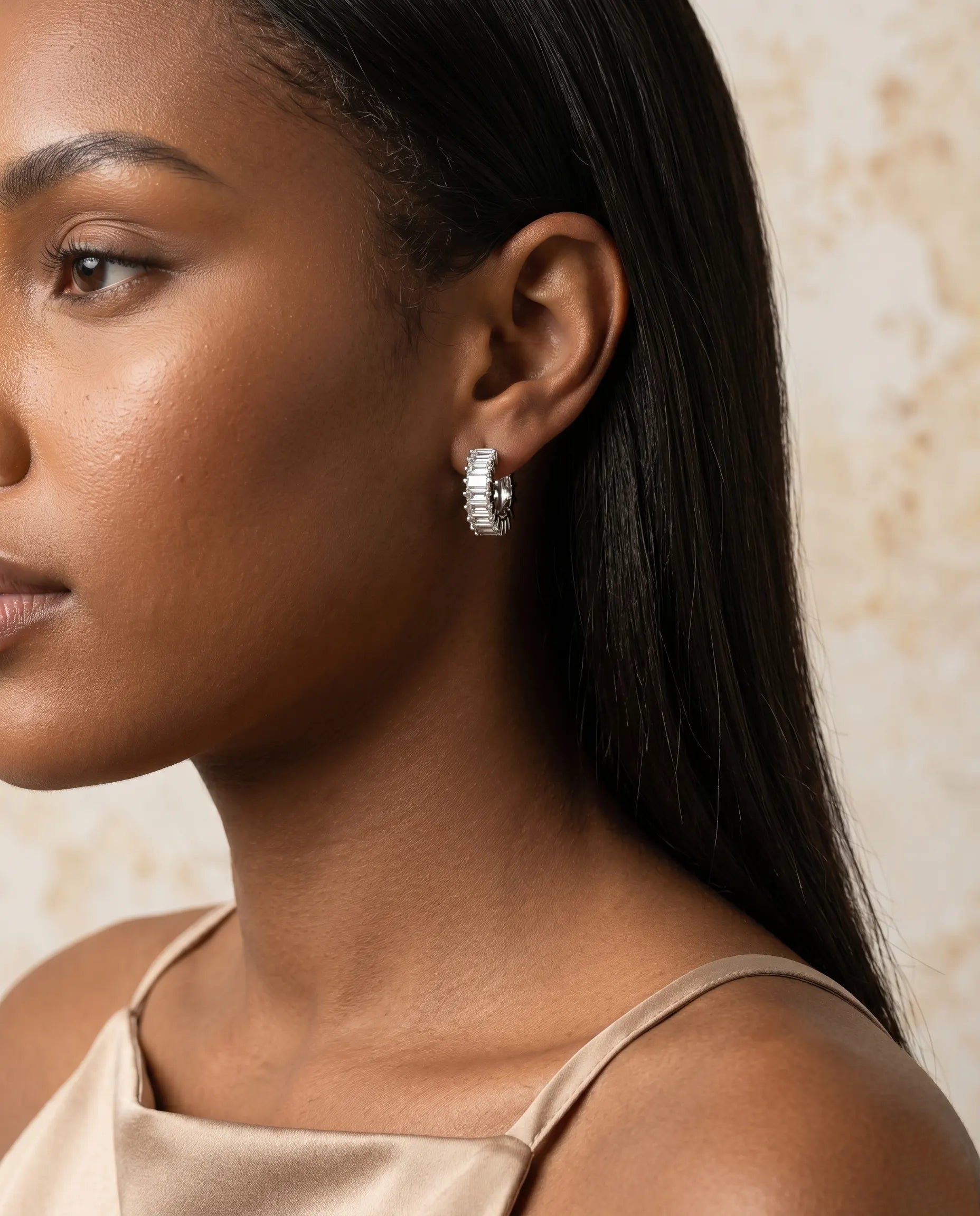 model-wearing-gold-lydia-baguette-huggie-earrings-lifestyle, elegant-modern-feminine-jewelry-on-ear, professional-women-luxury-accessories, chic-geometric-gold-styling, luxury-lifestyle-brand-model