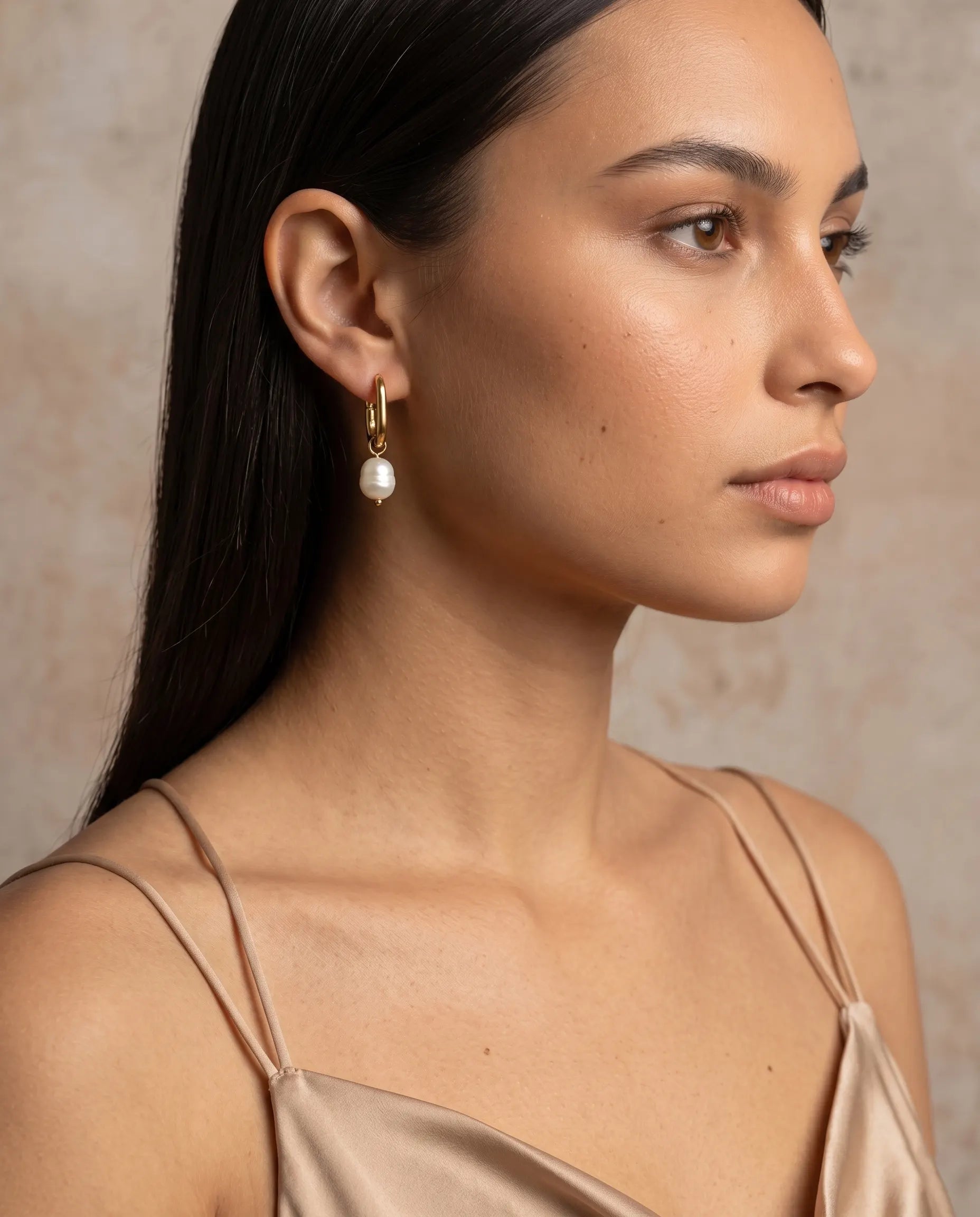 model-wearing-gold-pearly-earrings-lifestyle, elegant-modern-coastal-jewelry-on-ear, professional-women-luxury-accessories, chic-gold-pearl-drop-styling, luxury-lifestyle-brand-model