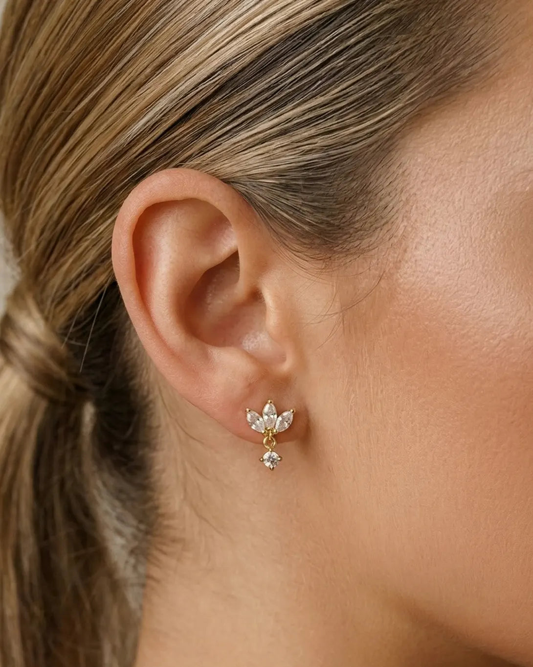 model-wearing-gold-sonea-flower-dangles, elegant-romantic-bloom-jewelry-lifestyle, professional-women-luxury-accessories, chic-floral-earring-photography, luxury-lifestyle-brand-model