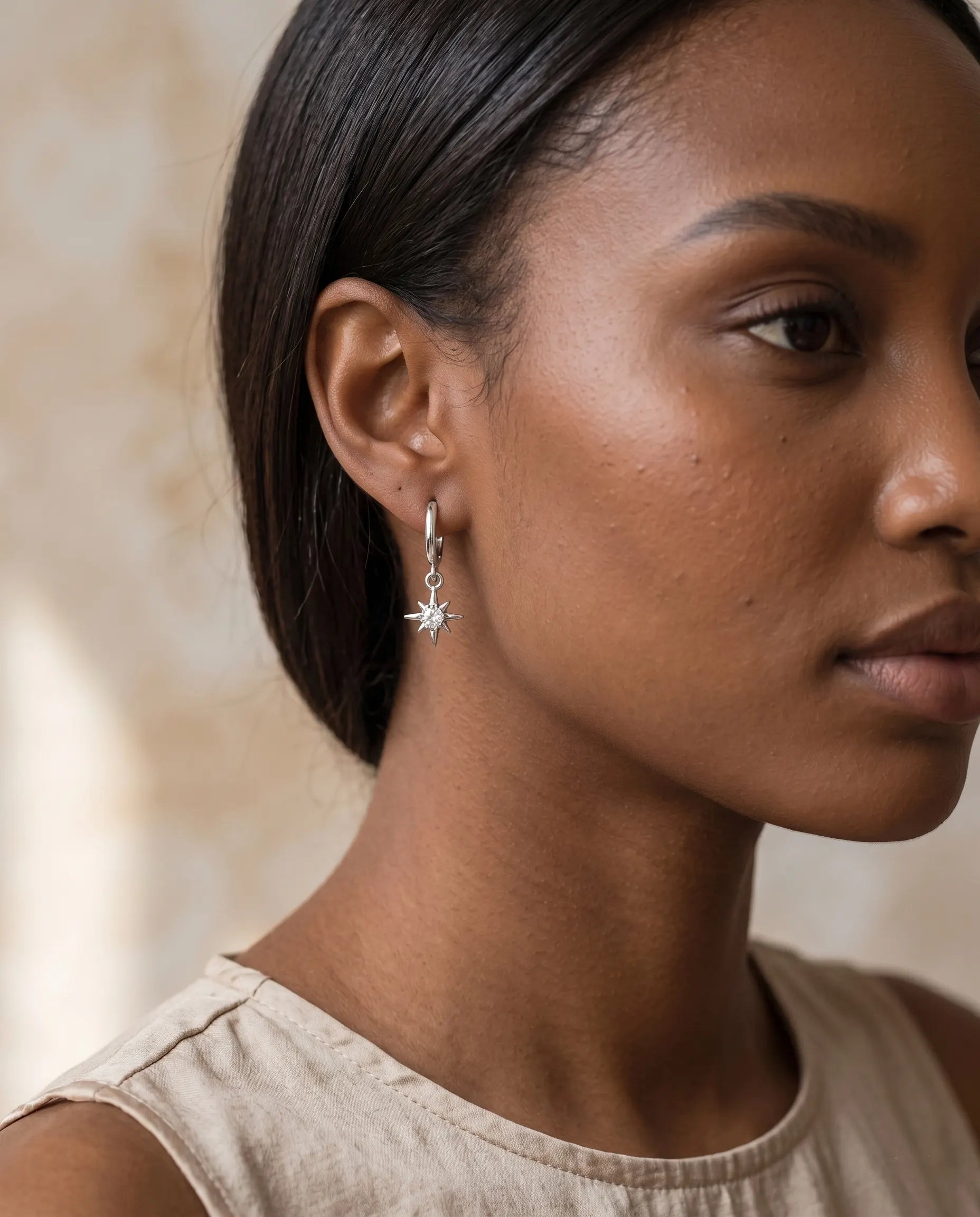 model-wearing-gold-stardust-star-earrings, elegant-celestial-jewelry-lifestyle, professional-women-jewelry-style, chic-modern-star-hoops-photography, luxury-lifestyle-brand-model, premium-celestial-accessories