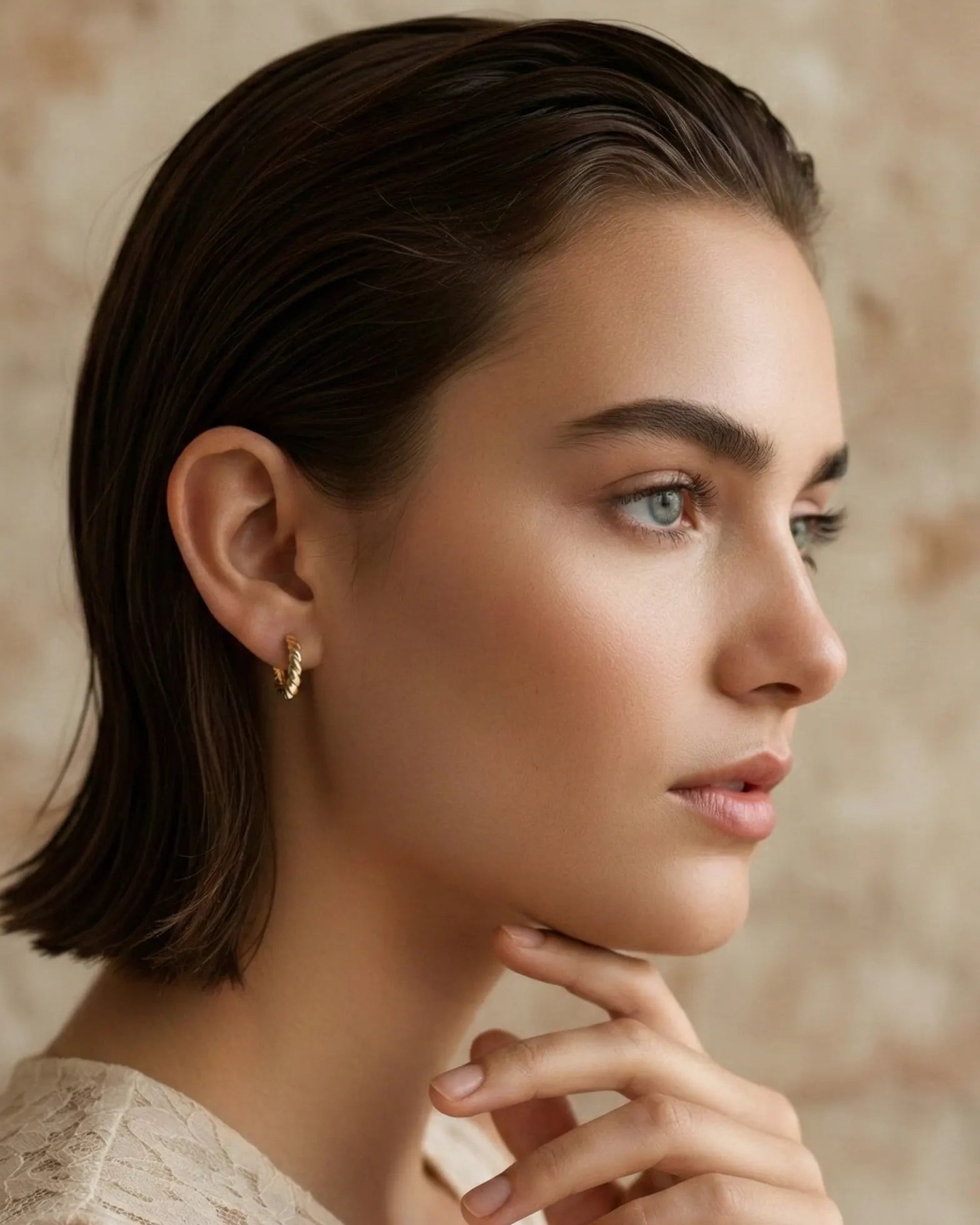model-wearing-gold-swirelle-twisted-earrings, elegant-effortless-sophistication-lifestyle, professional-women-jewelry-style, chic-minimalist-accessories-for-daily-wear, luxury-lifestyle-brand-photography, premium-jewelry-model-shot