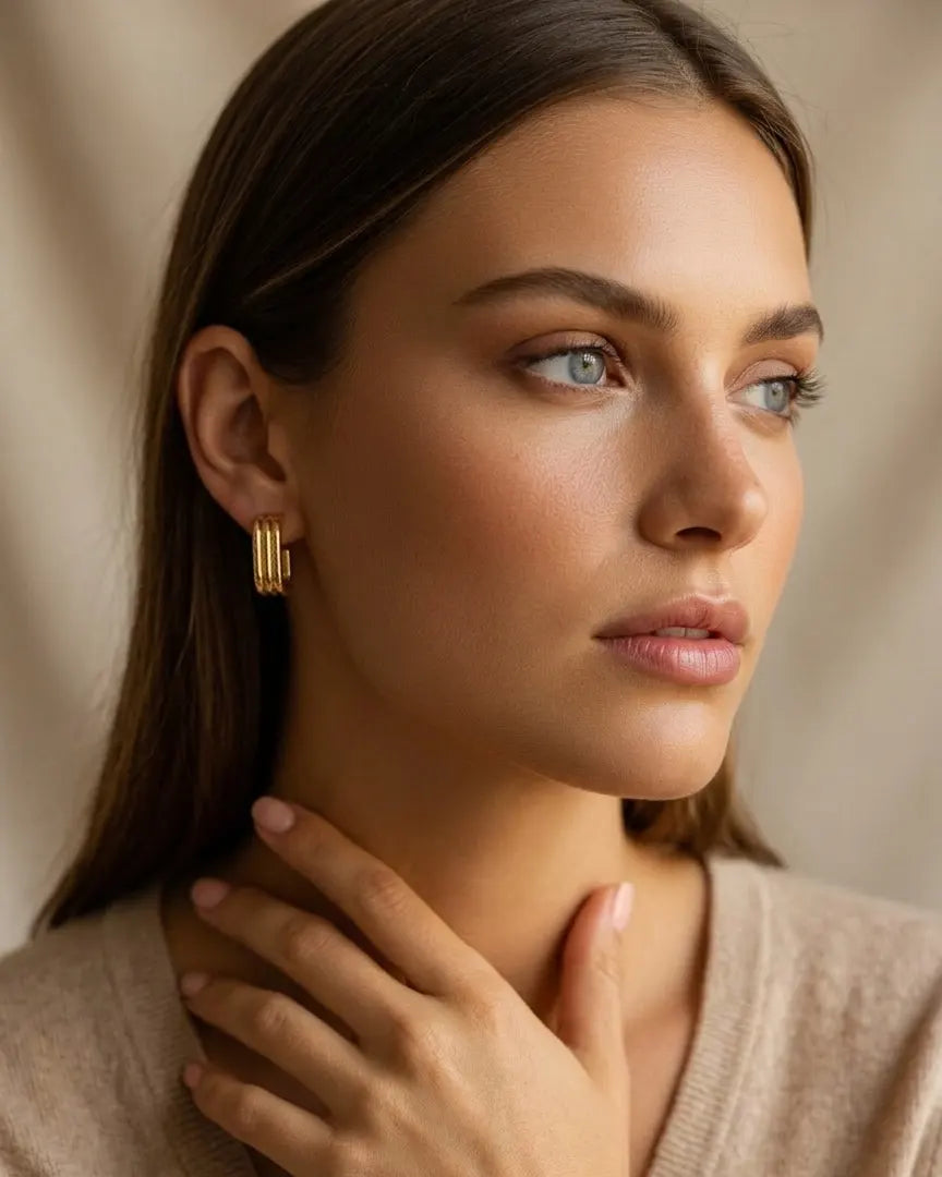 model-wearing-gold-ursula-rectangular-hoops-lifestyle, elegant-modern-bold-jewelry-on-ear, professional-women-luxury-accessories, chic-ribbed-geometric-earrings-styling, luxury-lifestyle-brand-model