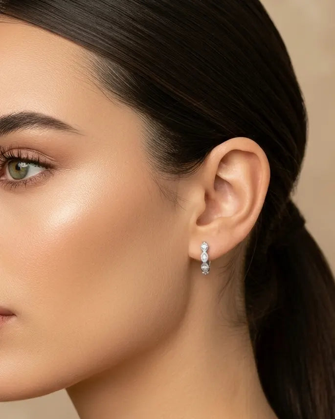 model-wearing-gold-verity-huggie-earrings, elegant-sparkling-earrings-lifestyle, professional-women-jewelry-style, chic-minimalist-accessories-for-office, luxury-lifestyle-brand-photography, premium-jewelry-model-shot