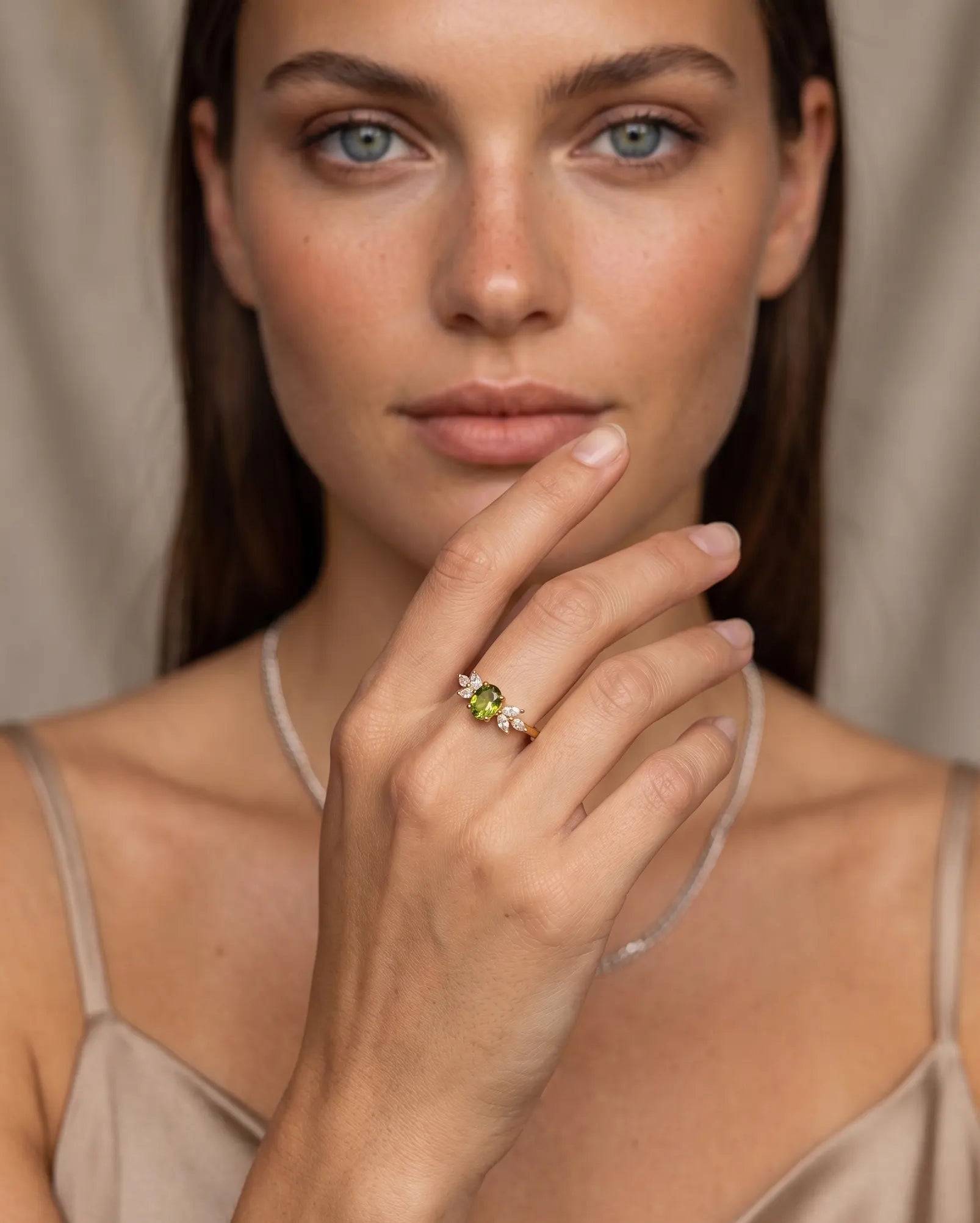 model-wearing-leona-green-ring-gold-plated, elegant-statement-jewelry-lifestyle, professional-women-jewelry-style, chic-minimalist-accessories-for-special-occasions, luxury-lifestyle-brand-photography, premium-jewelry-model-shot