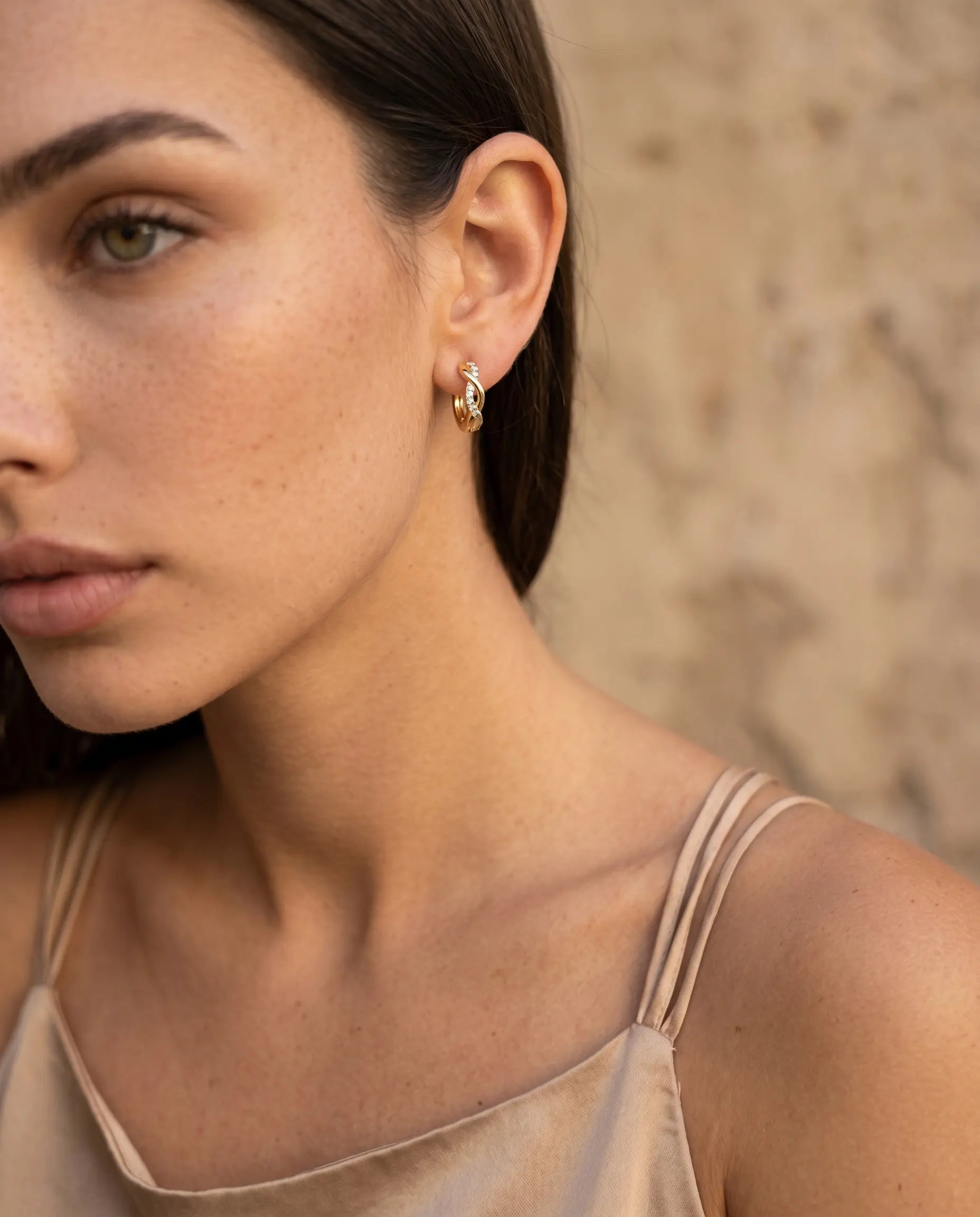 model-wearing-luiza-sterling-silver-zirconia-huggie-hoops-showcasing-1-2cm-fit-and-elegant-styling