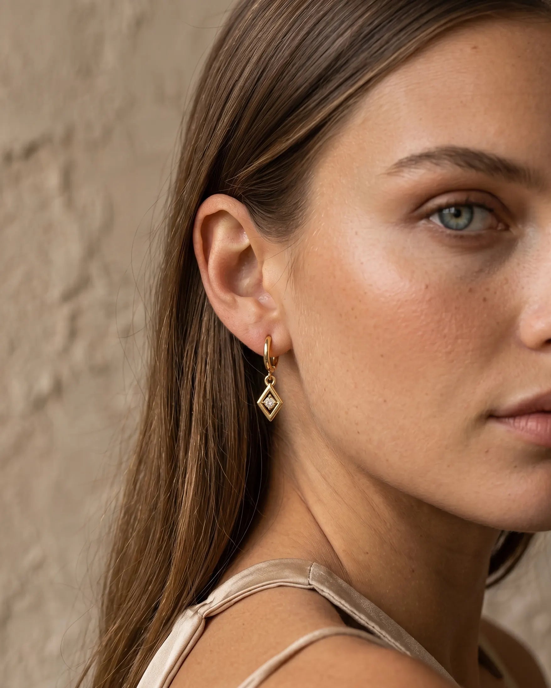 model-wearing-silver-charm-solitaire-drop-earrings-lifestyle, elegant-modern-feminine-jewelry-on-ear, professional-women-luxury-accessories, chic-micro-pave-silver-styling, luxury-lifestyle-brand-model