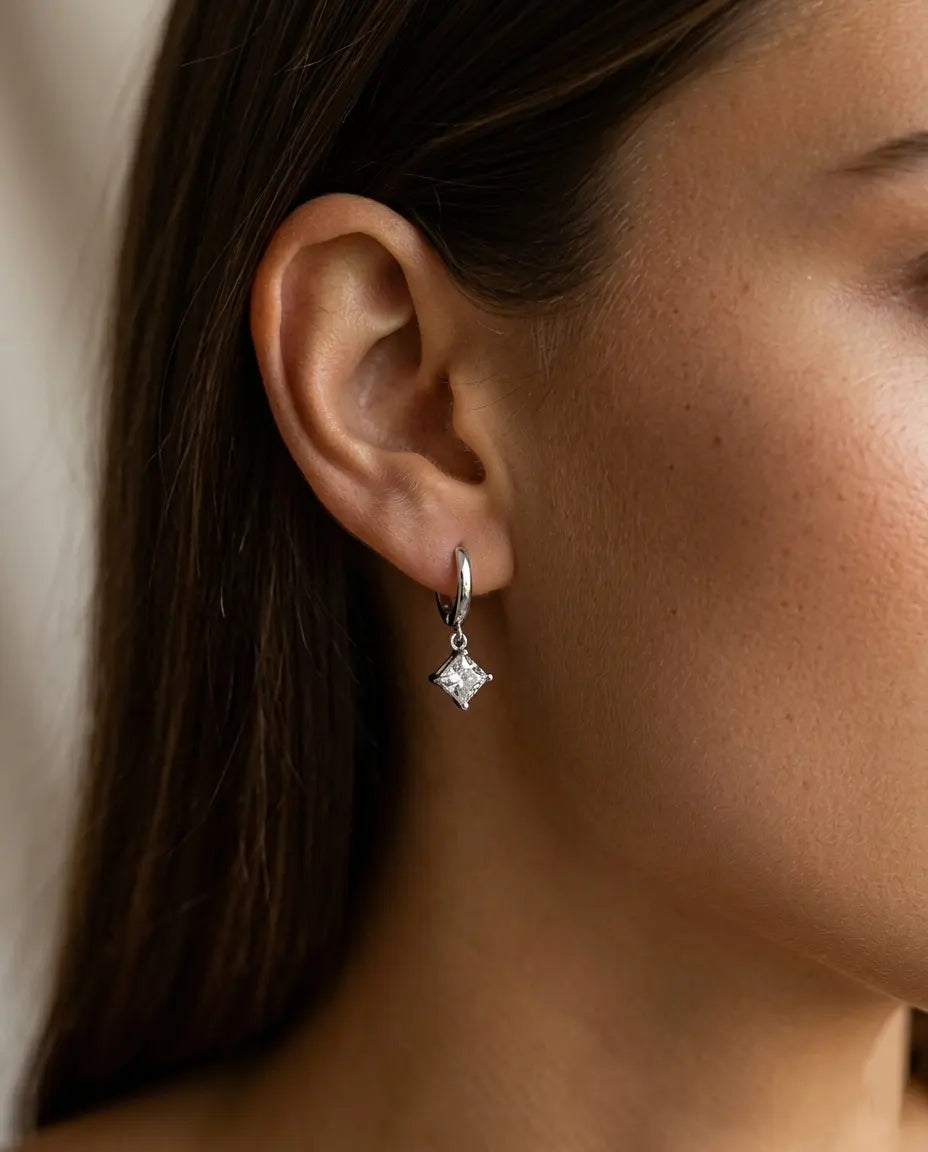 model-wearing-silver-davina-crystal-drop-earrings-lifestyle, elegant-modern-feminine-jewelry-on-ear, professional-women-luxury-accessories, chic-solitaire-silver-styling, luxury-lifestyle-brand-model