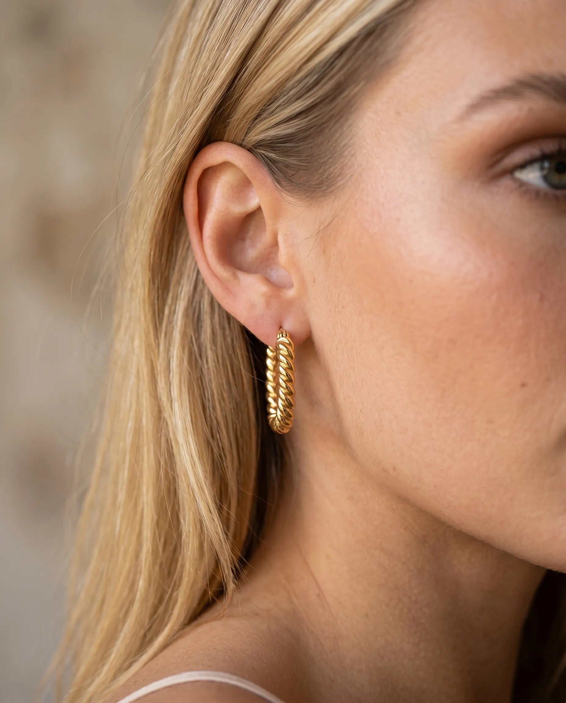 model-wearing-silver-mimi-beaded-huggie-earrings-lifestyle, elegant-modern-feminine-jewelry-on-ear, professional-women-luxury-accessories, chic-textured-silver-styling, luxury-lifestyle-brand-model