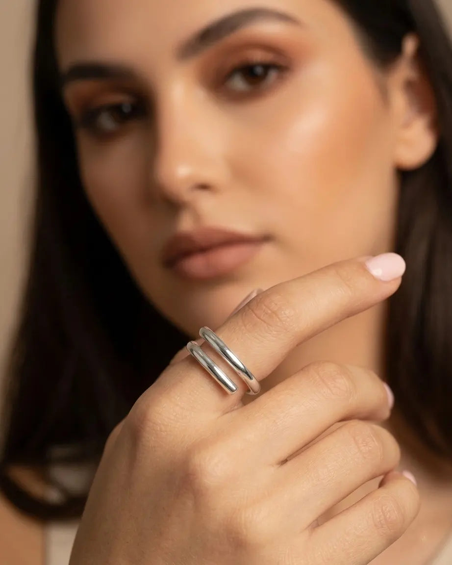 model-wearing-silver-peaceful-adjustable-ring-on-hand, elegant-minimalist-serenity-jewelry-lifestyle, professional-women-luxury-accessories, chic-double-band-silver-ring-photography, luxury-lifestyle-brand-model