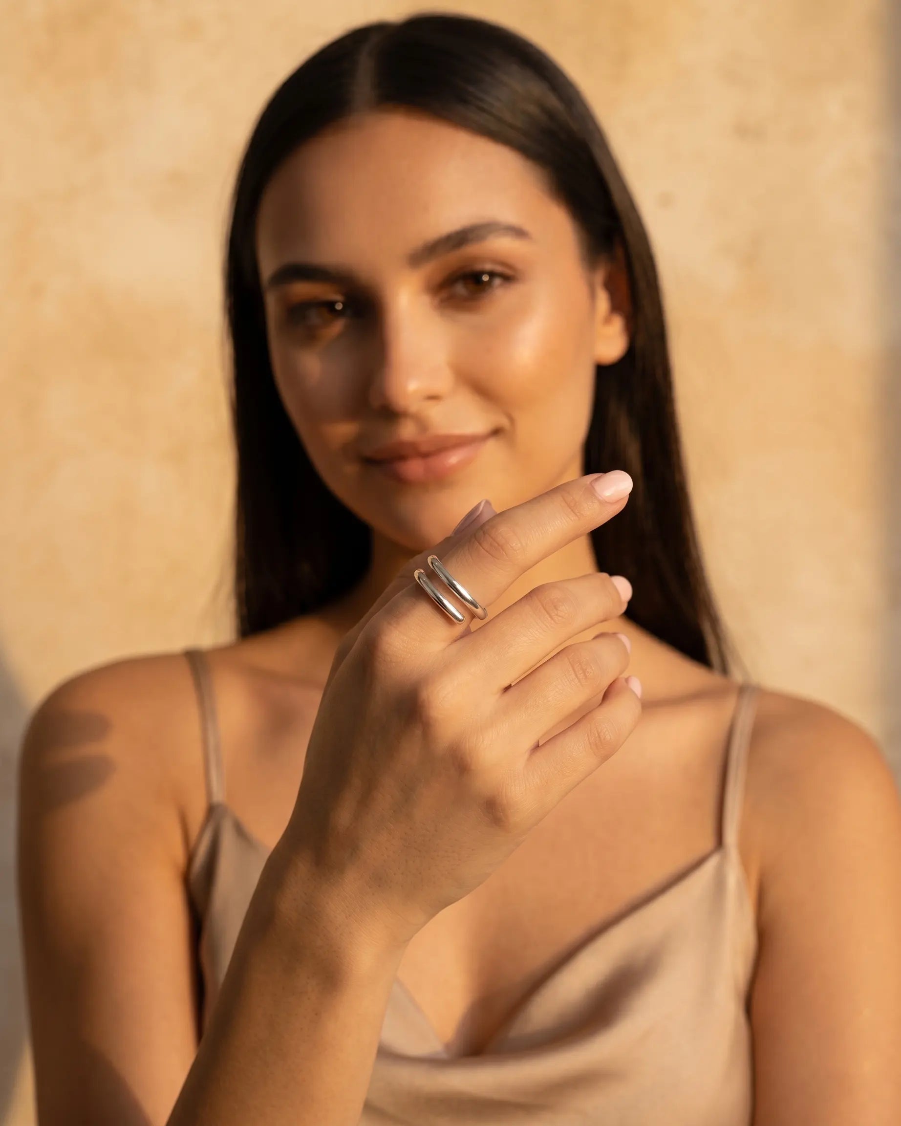 model-wearing-silver-peaceful-adjustable-ring-on-hand, elegant-minimalist-serenity-jewelry-lifestyle, professional-women-luxury-accessories, chic-double-band-silver-ring-photography, luxury-lifestyle-brand-model