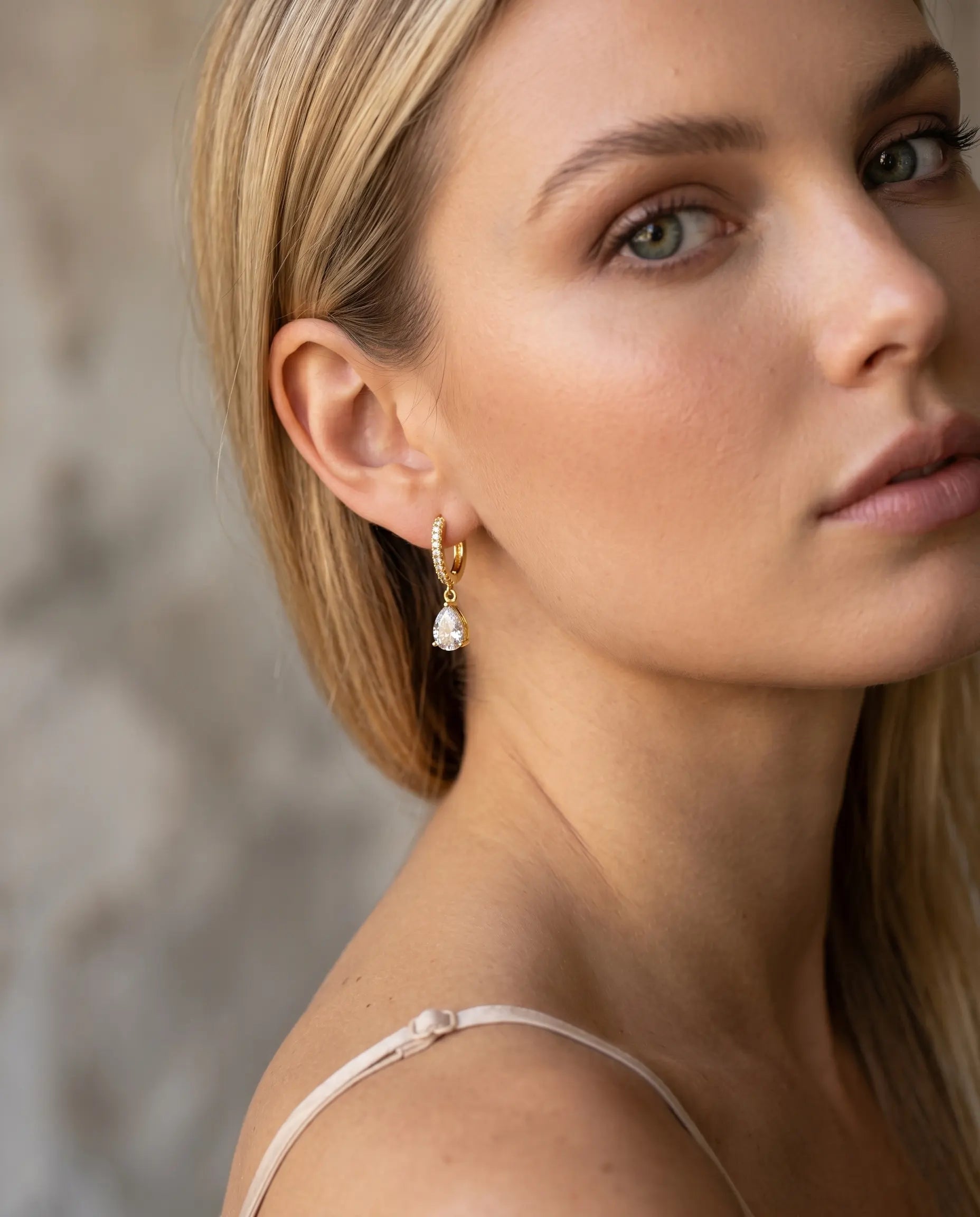 model-wearing-silver-quiola-teardrop-huggies, elegant-radiance-jewelry-lifestyle, professional-women-luxury-accessories, chic-minimalist-earring-photography, luxury-lifestyle-brand-model