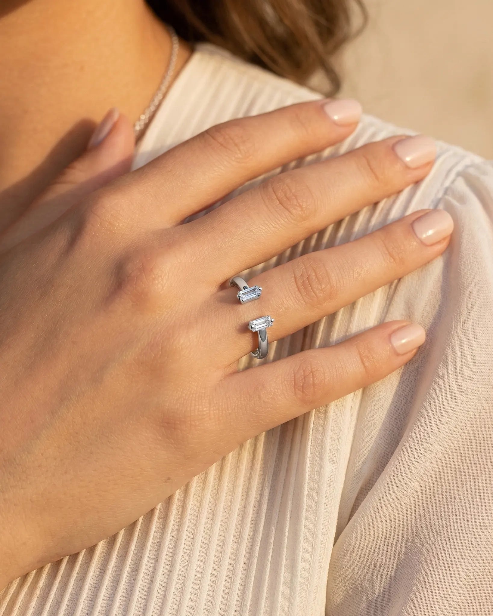 model-wearing-silver-spring-open-ring-on-hand, elegant-minimalist-stacking-jewelry-lifestyle, professional-women-luxury-accessories, chic-geometric-silver-ring-photography, luxury-lifestyle-brand-model