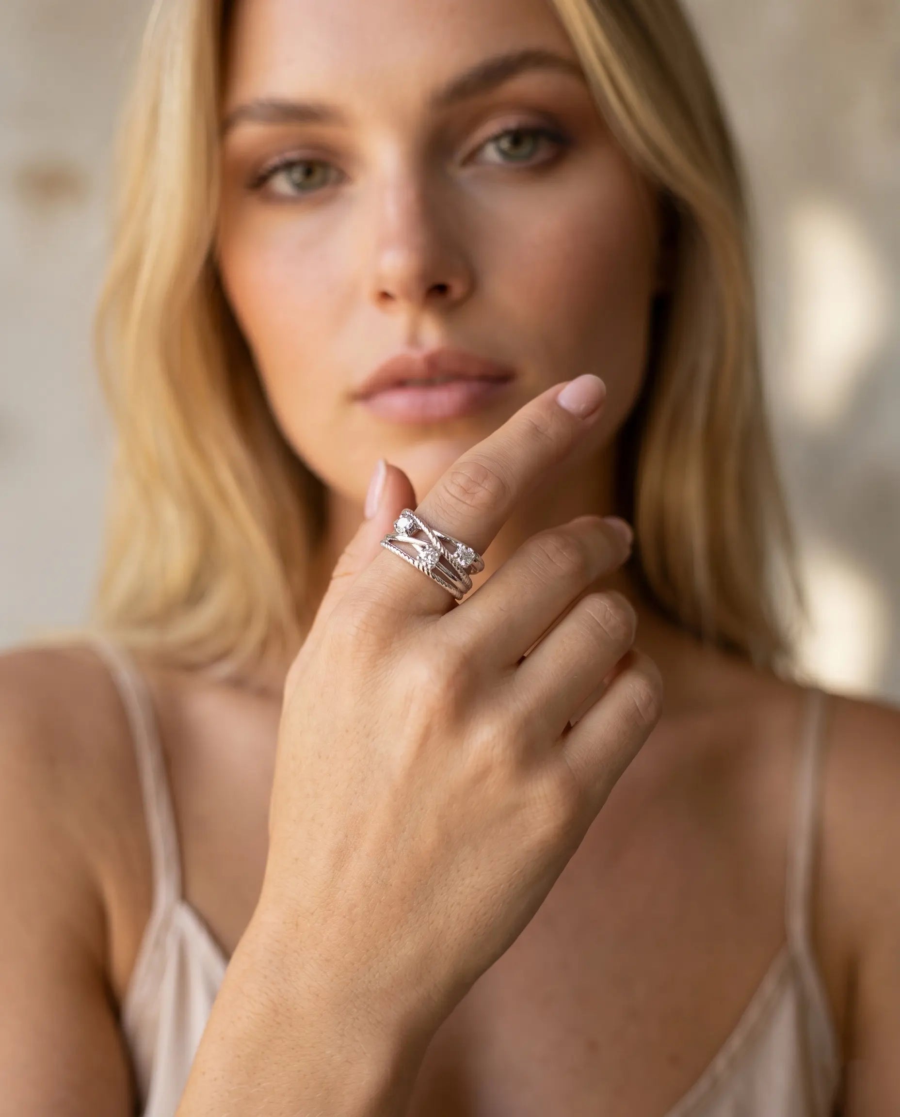 model-wearing-silver-titania-knot-ring-lifestyle, elegant-modern-feminine-jewelry-on-hand, professional-women-luxury-accessories, chic-pave-silver-styling, luxury-lifestyle-brand-model