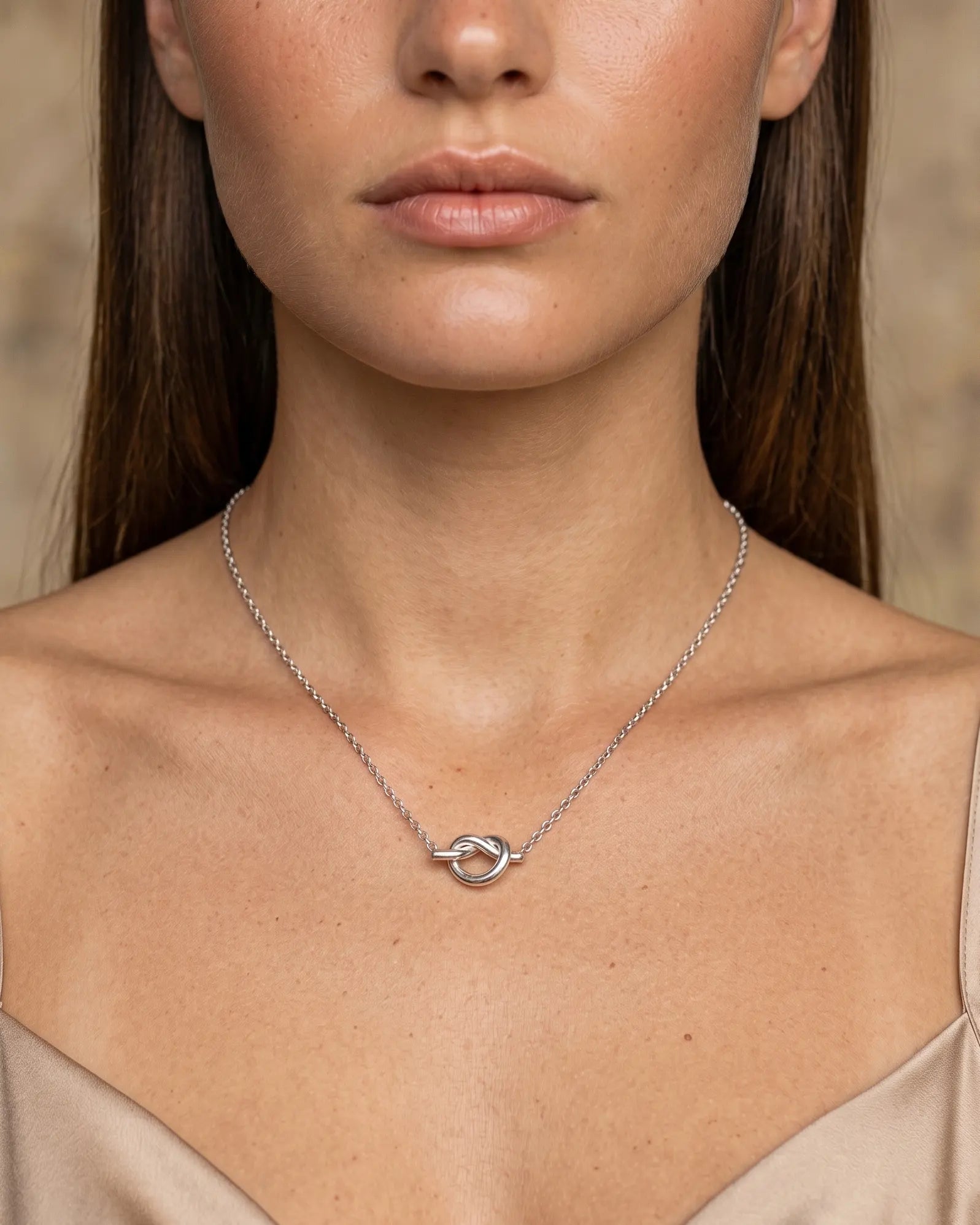 model-wearing-the-nerissa-knot-necklace-showcasing-delicate-pendant-and-perfect-neckline-fit-minimalist-styling