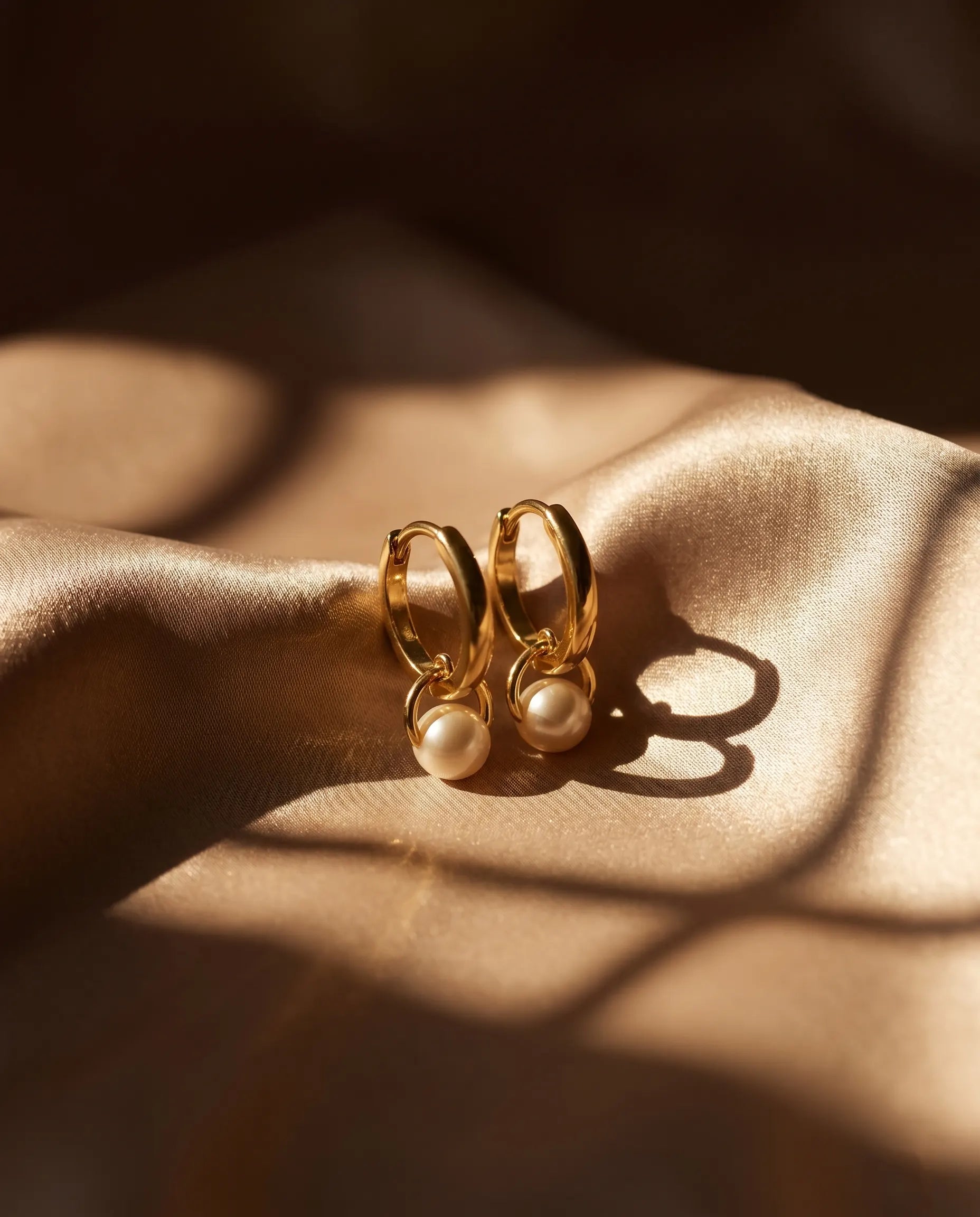 palma-pearl-drop-huggie-hoops-captured-in-warm-natural-light-to-emphasize-the-elegant-and-minimalist-design