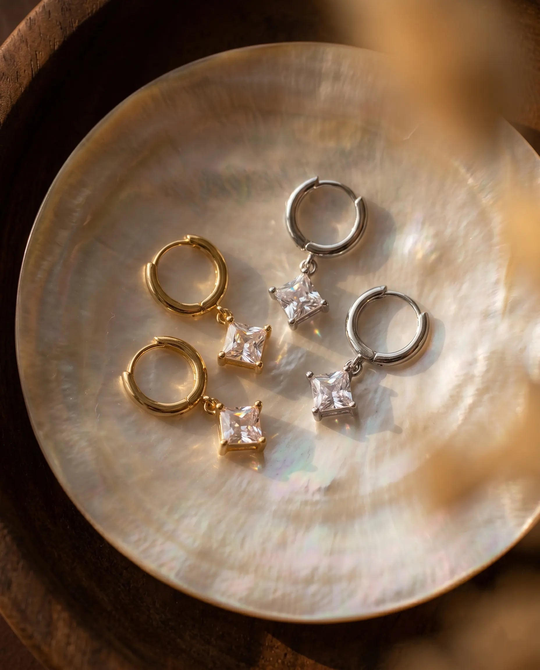 timeless-celestial-aesthetic-davina-sparkling-earrings-gold-silver, 18k-gold-vermeil-finish-detail-drop-huggies, gift-ideas-for-women-opal-effect-jewelry, luxury-boutique-jewelry-netherlands, artistic-jewelry-flatlay-photography