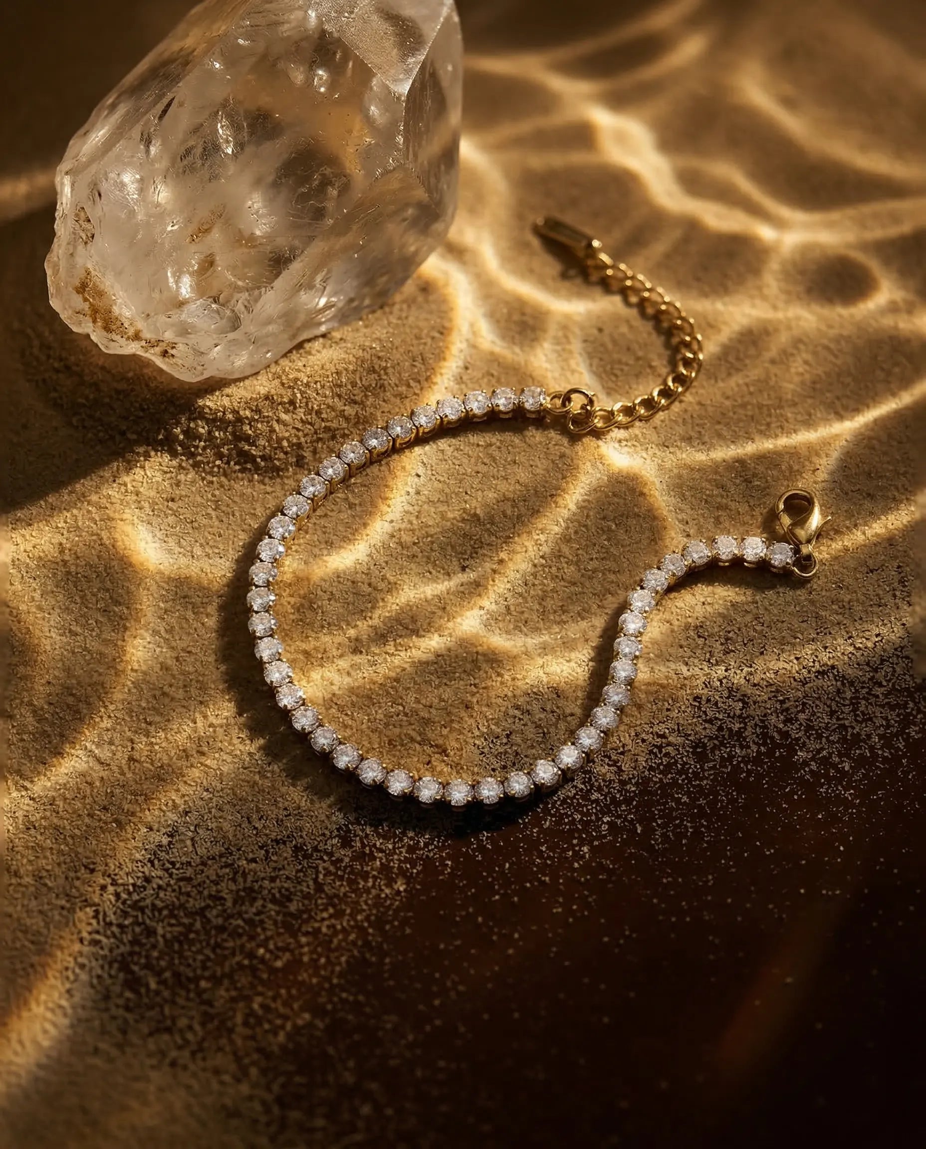 timeless-modern-aesthetic-tennis-bracelet-gold, 18k-gold-pvd-finish-detail-elena-crystal-chain, gift-ideas-for-women-sparkling-jewelry, luxury-boutique-jewelry-netherlands, artistic-jewelry-flatlay-photography