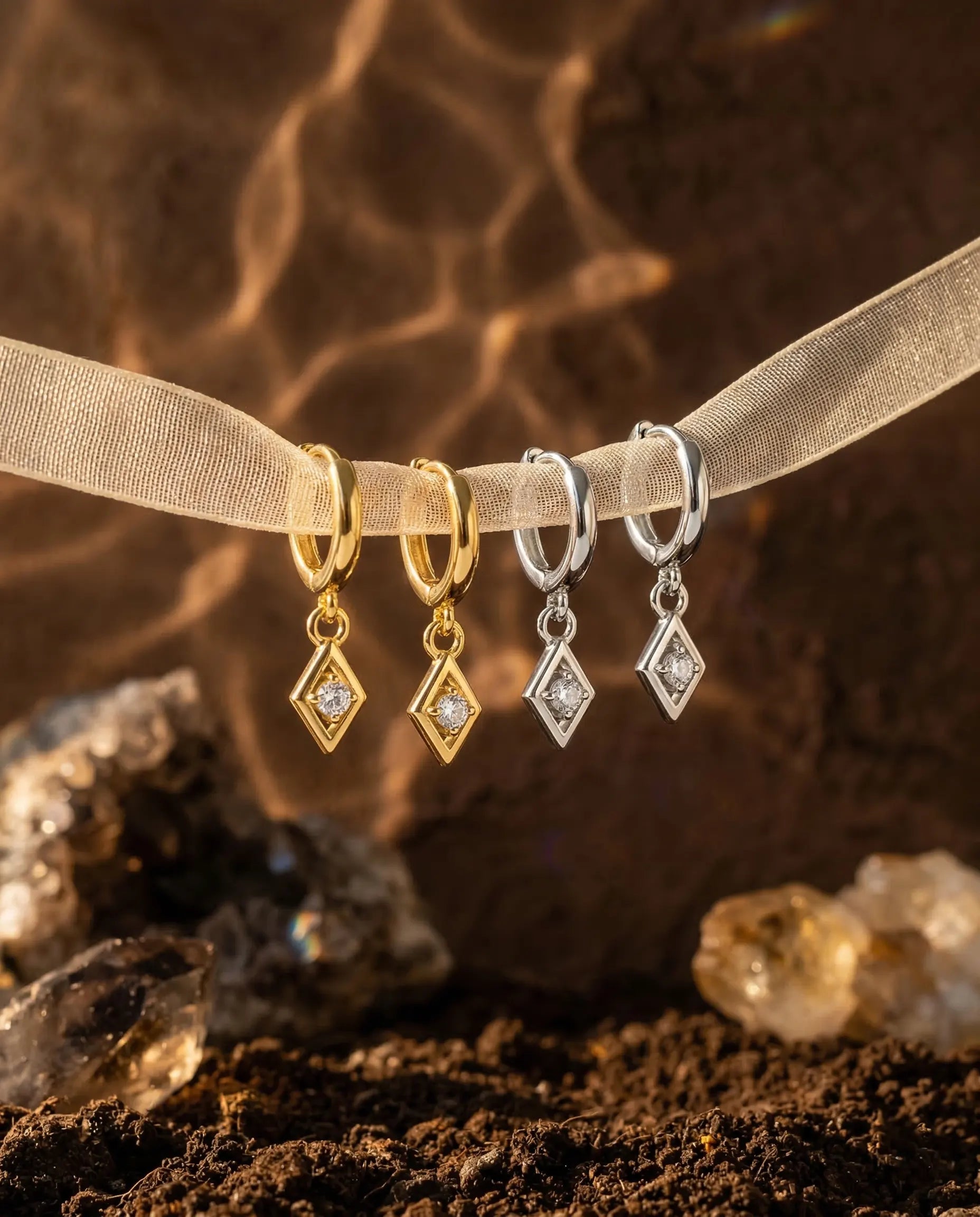timeless-quiet-luxury-aesthetic-charm-sparkling-earrings-gold-silver, 18k-gold-finish-detail-solitaire-drops, gift-ideas-for-women-elegant-sparkle-jewelry, luxury-boutique-jewelry-netherlands, artistic-jewelry-flatlay-photography
