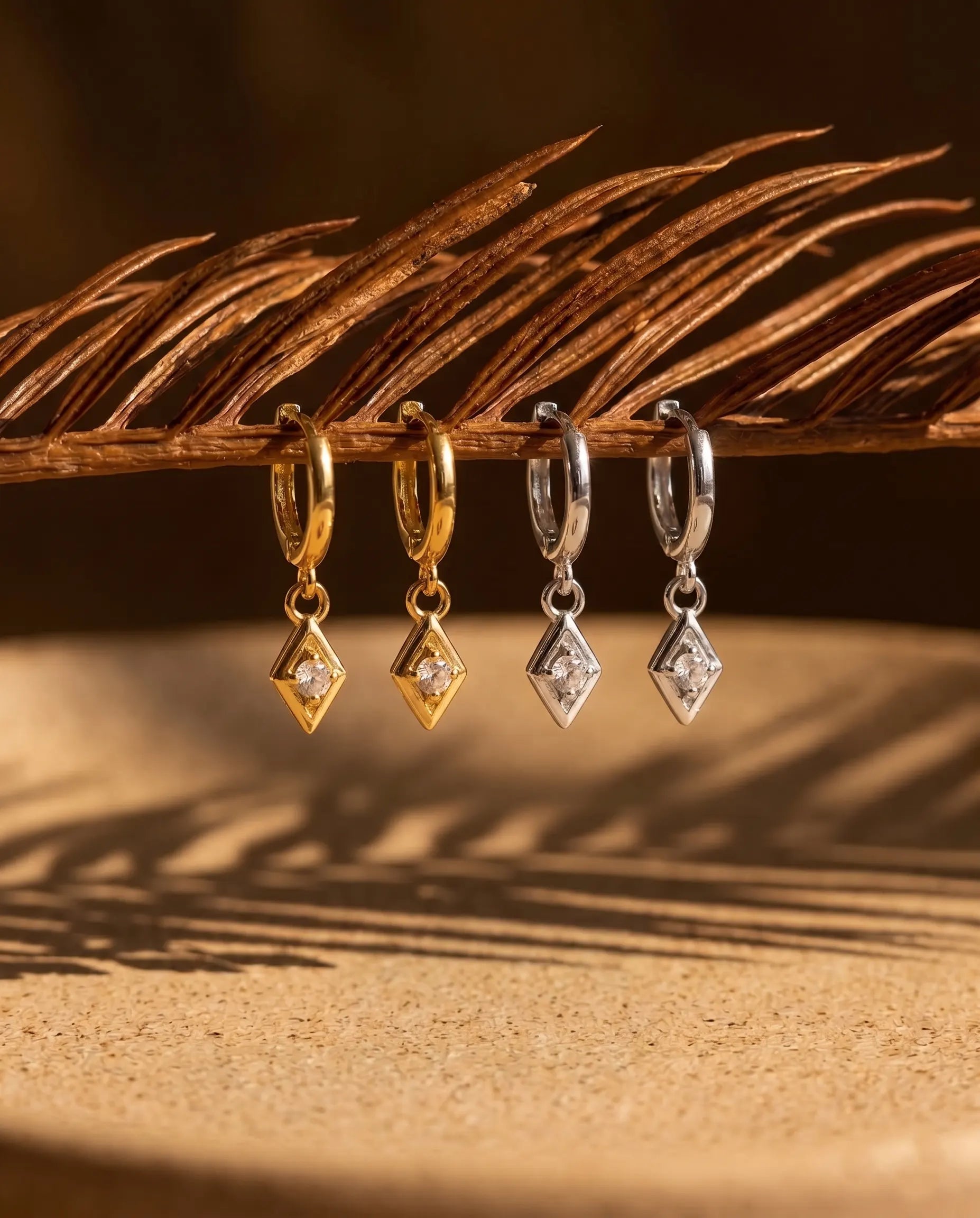 timeless-quiet-luxury-aesthetic-charm-sparkling-earrings-gold-silver, 18k-gold-finish-detail-solitaire-drops, gift-ideas-for-women-elegant-sparkle-jewelry, luxury-boutique-jewelry-netherlands, artistic-jewelry-flatlay-photography