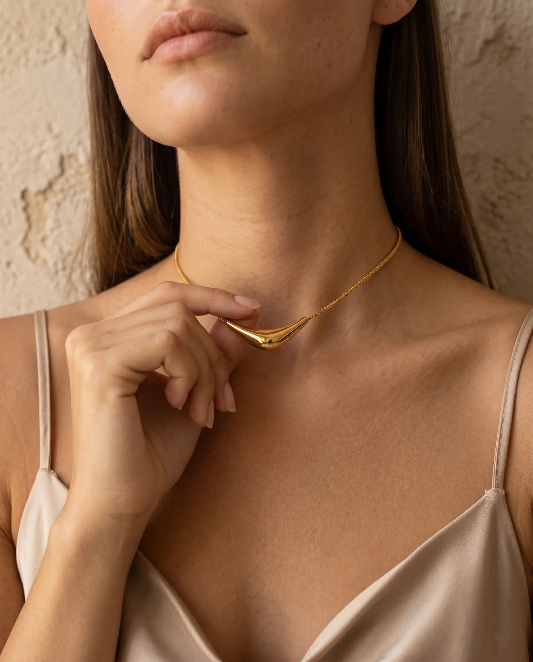 versatile-daily-wear-gold-prestige-statement-necklace, effortless-high-end-sculptural-style, minimalist-accessories-for-refined-look, classy-stainless-steel-arc-necklace-lifestyle, senya-jewelry-prestige-collection