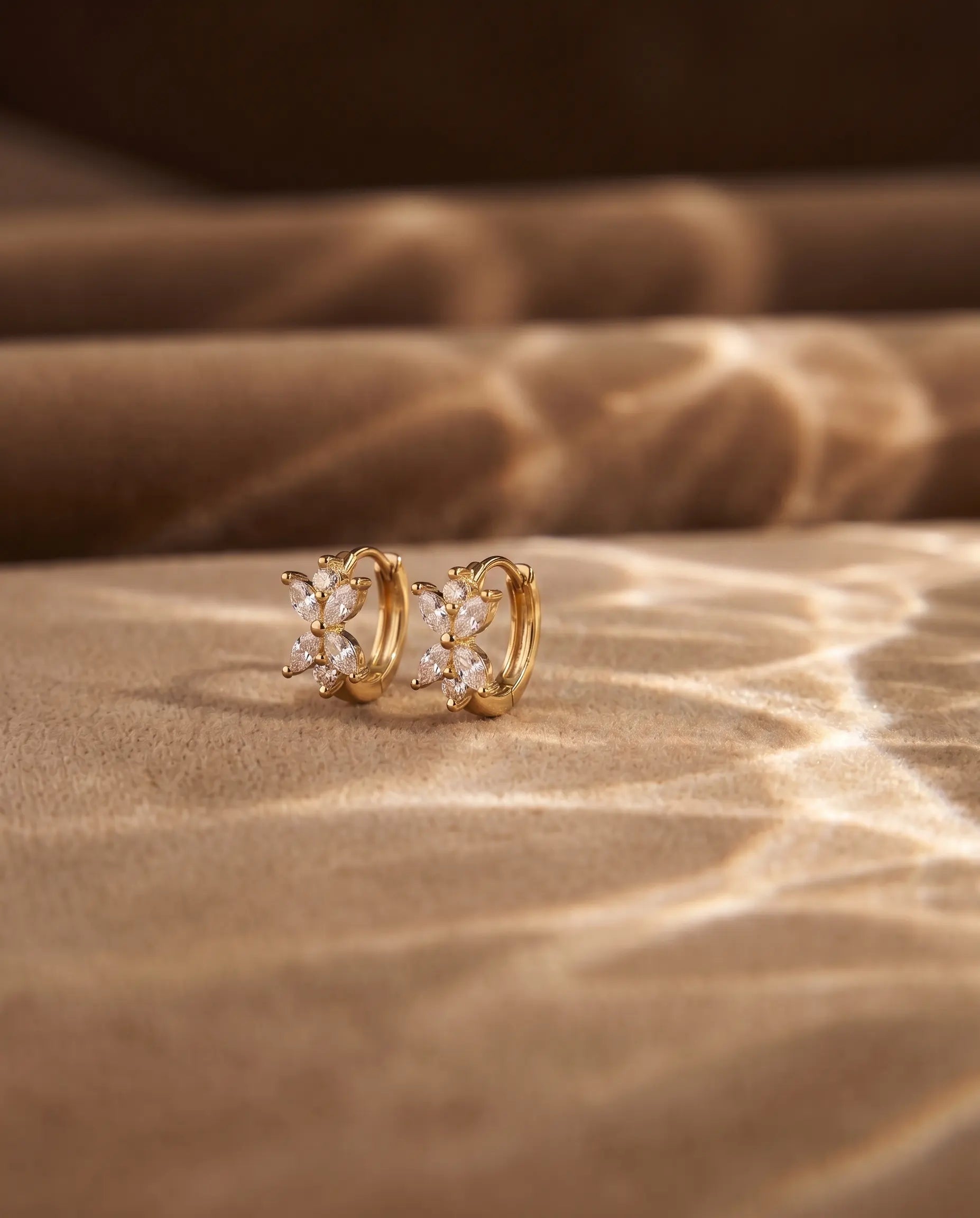 zirconia-butterfly-huggie-hoops-captured-in-warm-natural-light-to-emphasize-the-ethereal-design