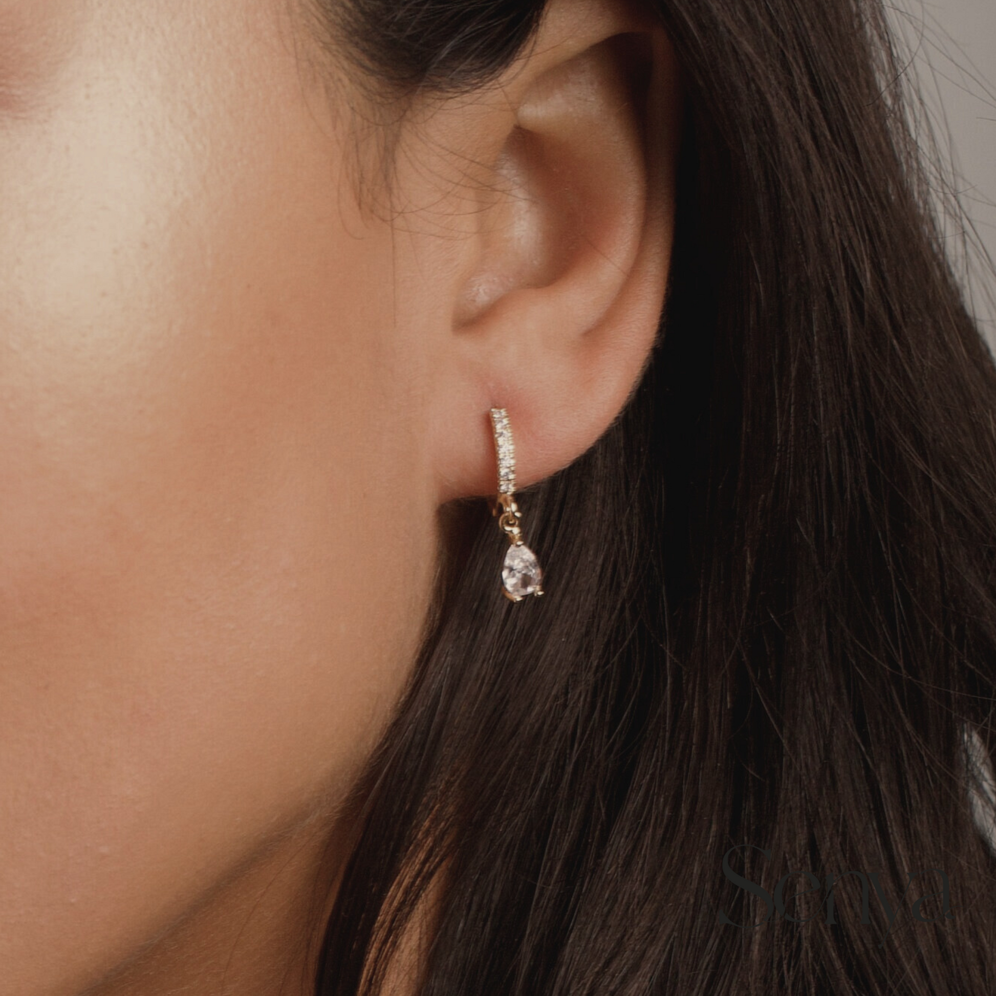 Pear-shaped zirconia earrings, Hoop earrings with stunning zirconia details, Zirconia-filled hoops with pear-shaped centerpiece, Earrings with shimmering white zirconias, Pear-shaped zirconia hoop earrings.