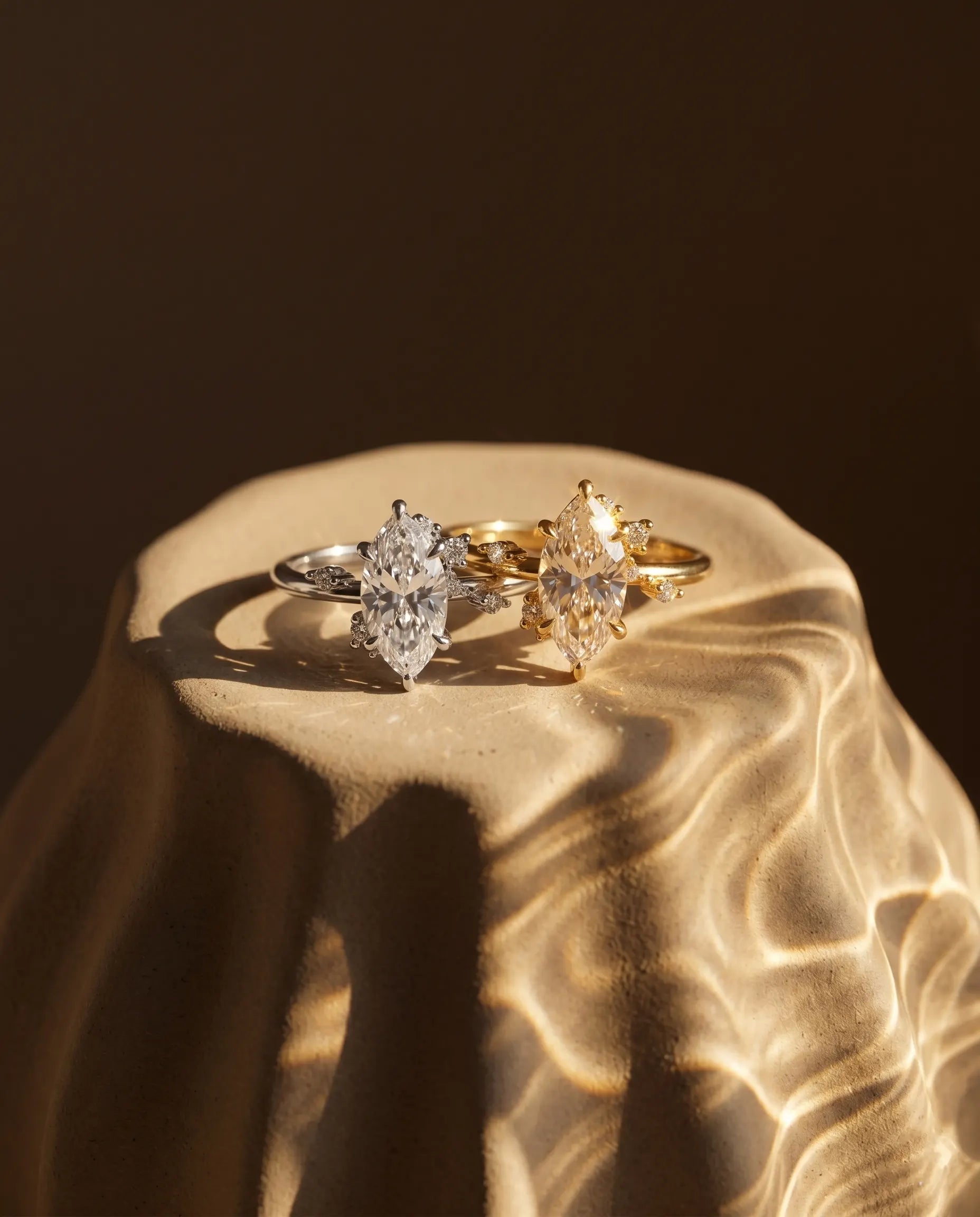 artistic-jewelry-display-maesta-marquise-ring-silver-gold, creative-still-life-luxury-accessories, premium-fine-jewelry-showcase, modern-sculptural-ring-presentation