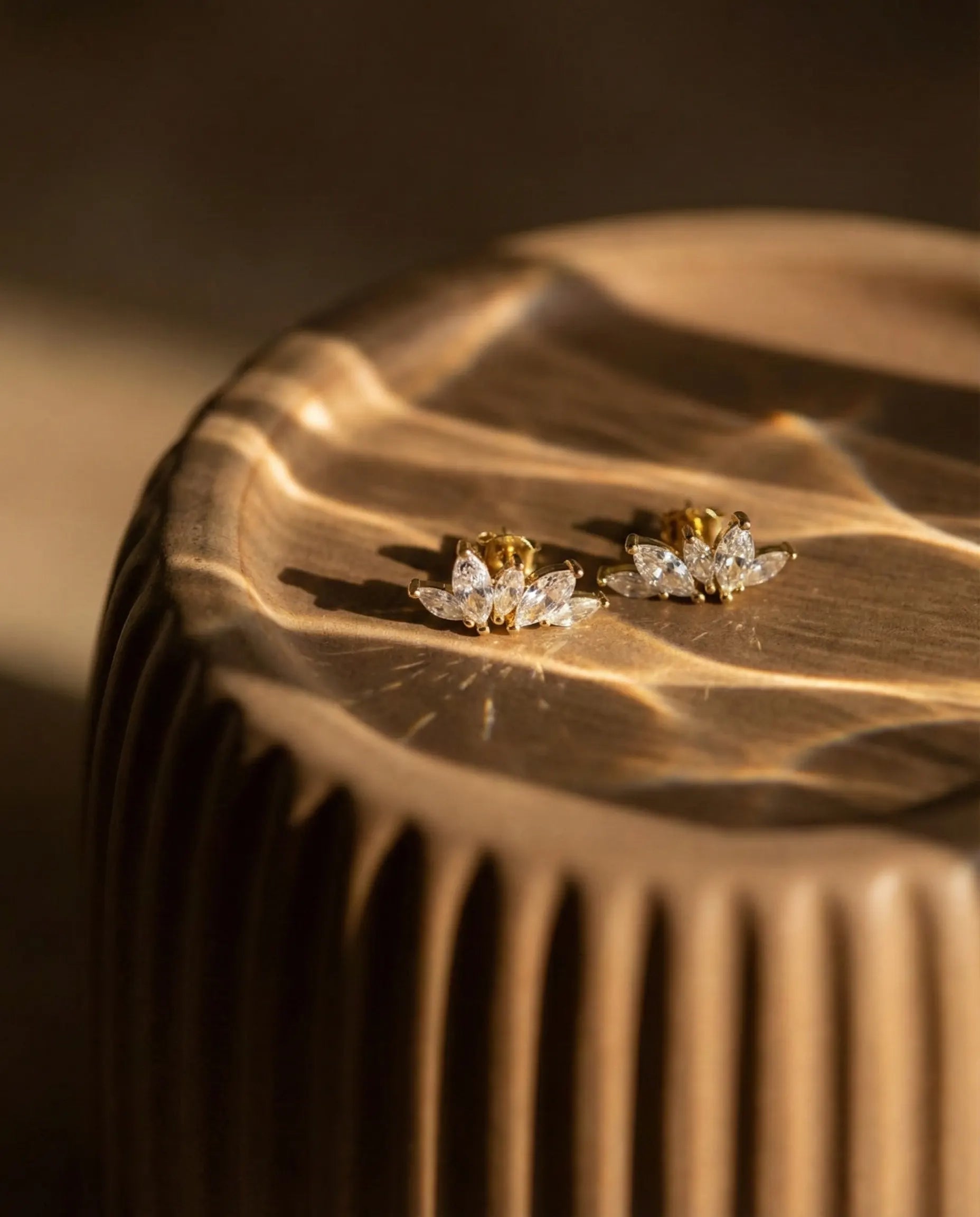 bliss-crystal-stud-earrings-resting-on-minimalist-display-photography-for-luxury-jewelry-enthusiasts