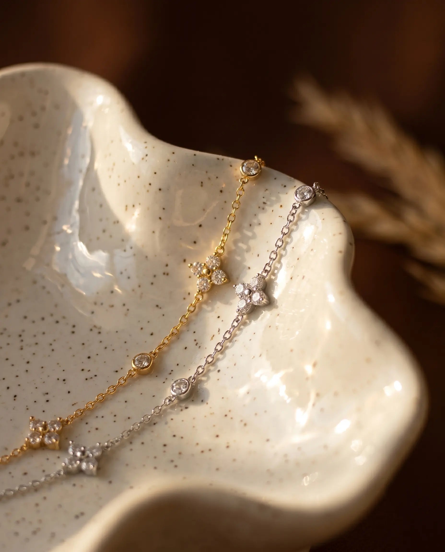 chloe-flower-bracelet-artistic-shot-in-natural-warm-light-showcasing-the-delicate-chain-and-floral-charms