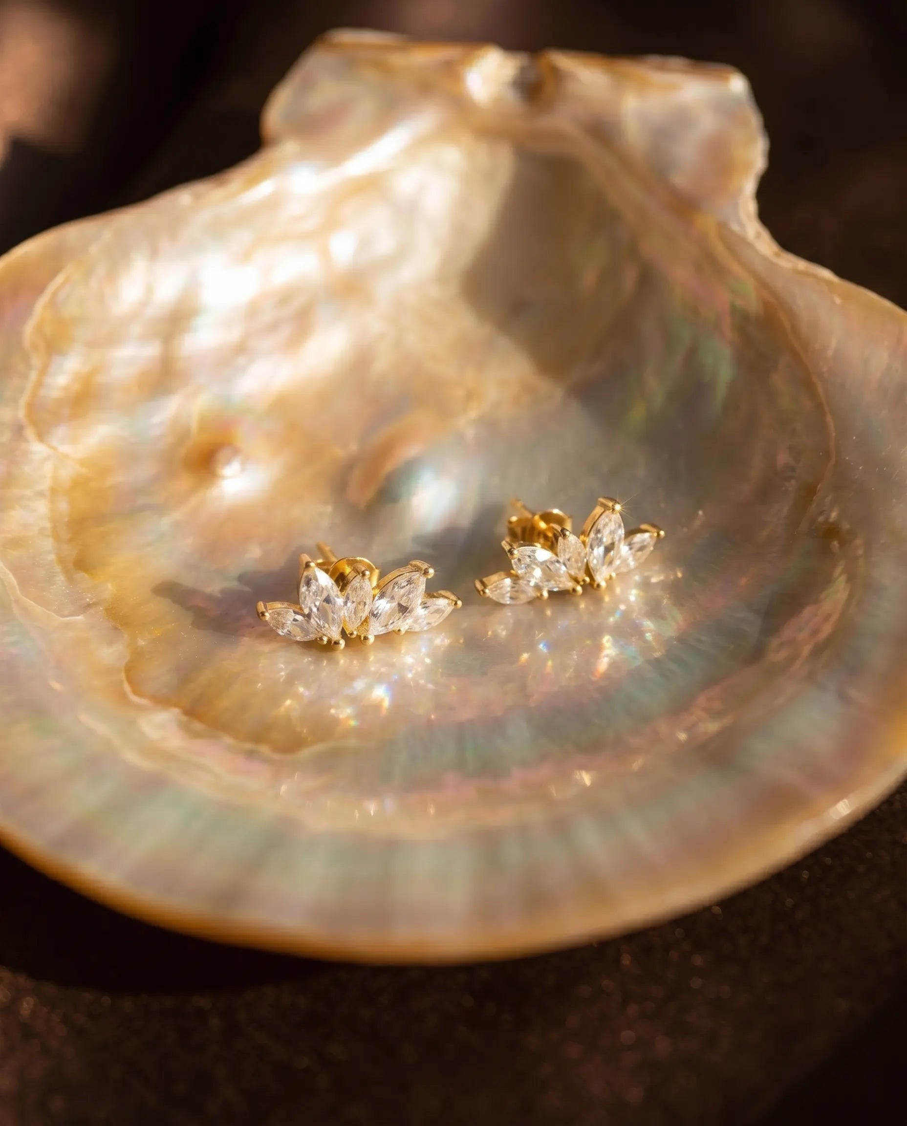 close-up-of-bliss-crystal-studs-displayed-on-mother-of-pearl-highlighting-marquise-cut-brilliance-and-sterling-silver-quality