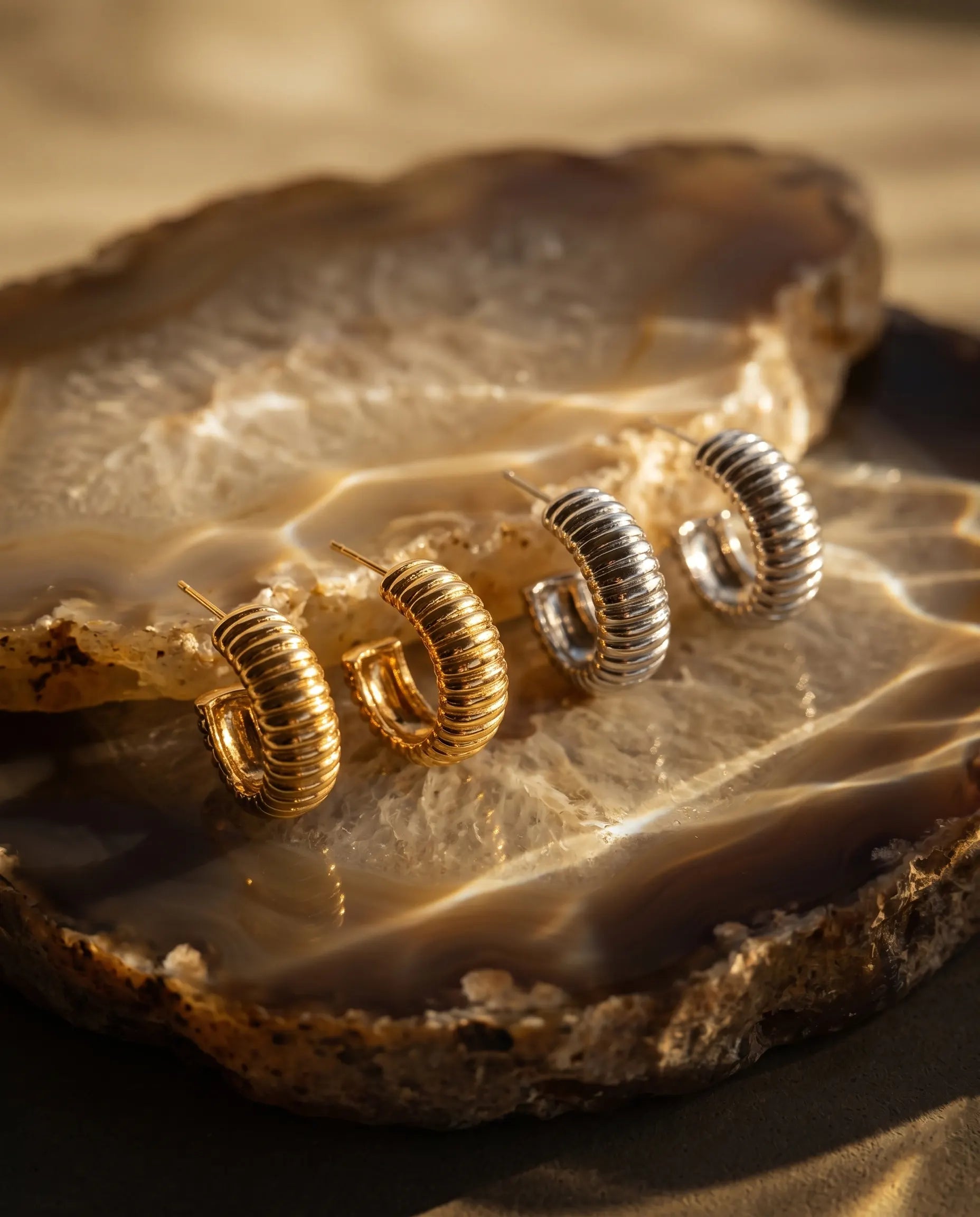 close-up-of-glam-ribbed-earrings-displayed-on-agate-highlighting-textural-detail-and-stainless-steel-quality