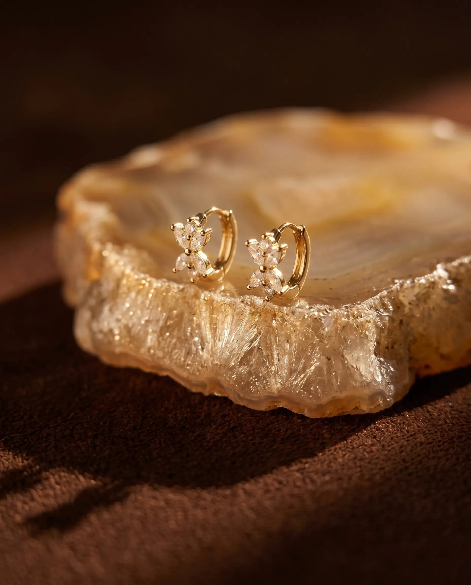 close-up-of-mirabel-butterfly-studs-displayed-on-agate-slice-highlighting-zirconia-brilliance-and-sterling-silver-quality